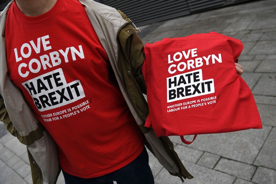 Labour activist wearing a "Love Corbyn Hate Brexit" t-shirt and holding another in his hand