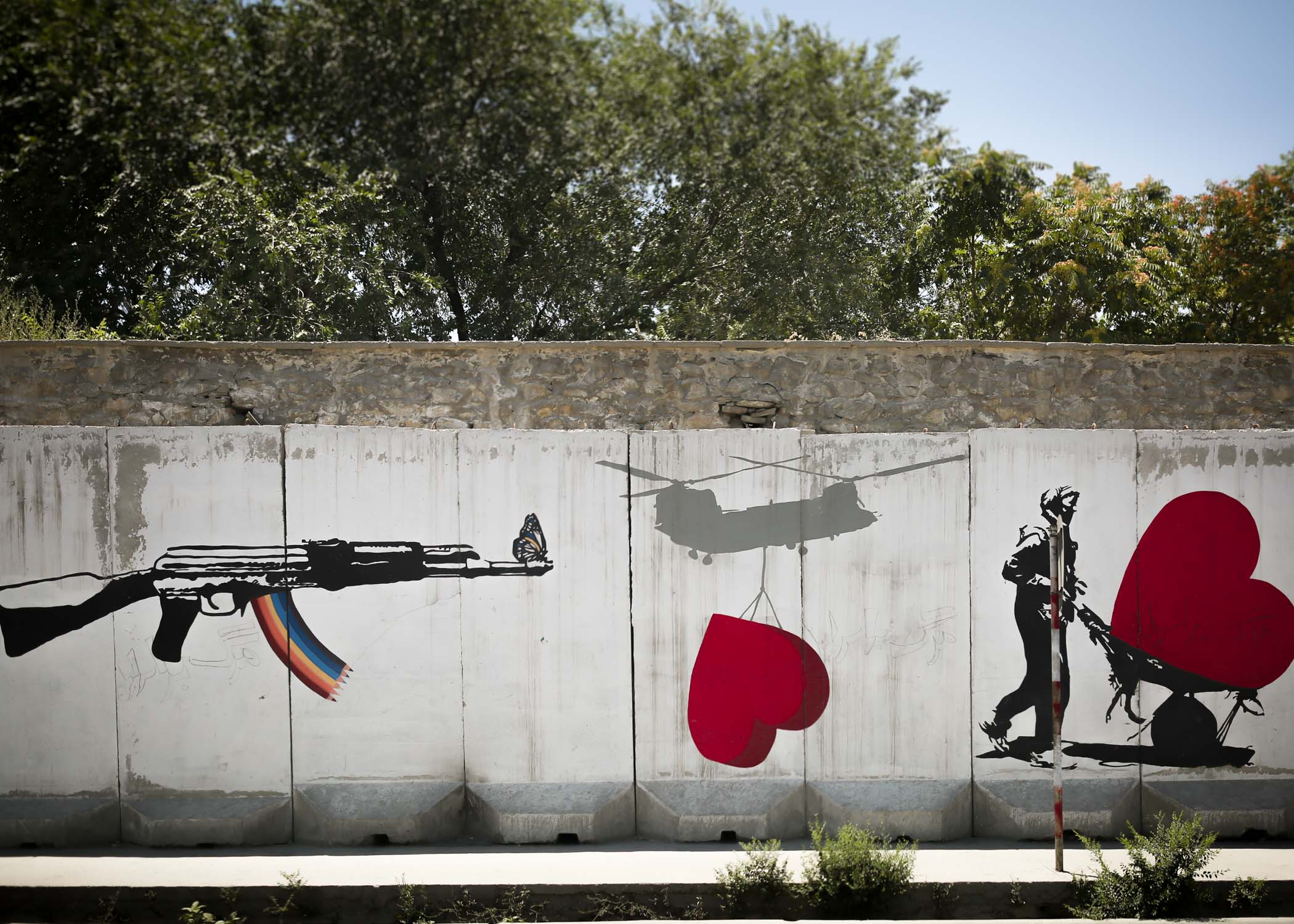A wall of graffiti in Kabul depicting instead of guns and bombs, love hearts