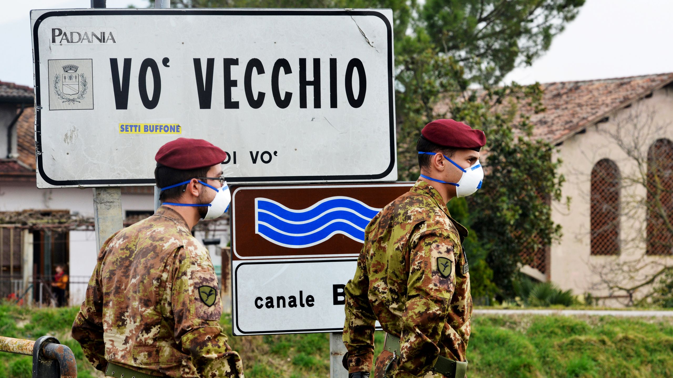 Italian soldiers patrol the perimeter of the small town