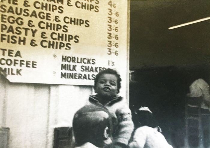 Malik as a small boy, being carried