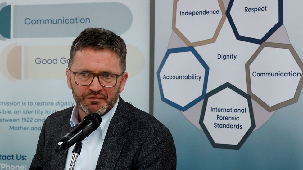 Daniel MacSweeney pictured speaking into a microphone.