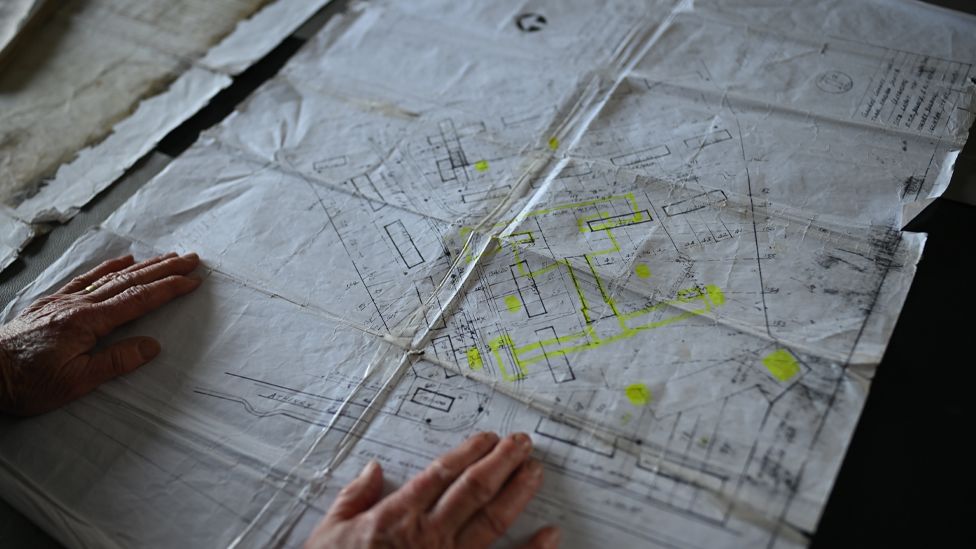 Black and white plans of the site with some areas highlighted in yellow.