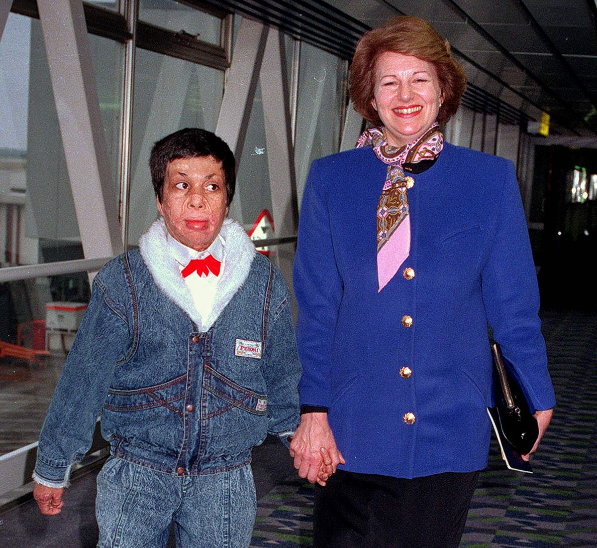 Amar holding hands with Emma Nicholson