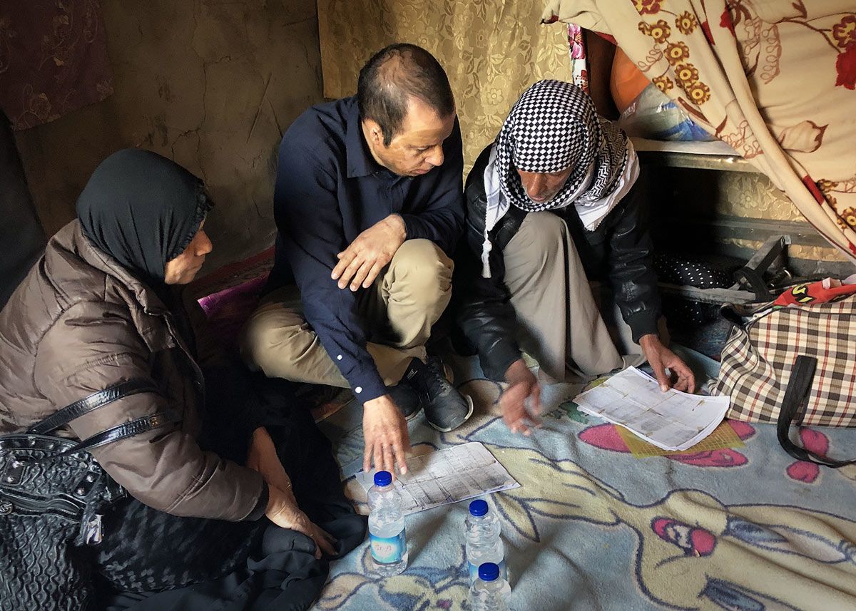 Amar with family looking at documents