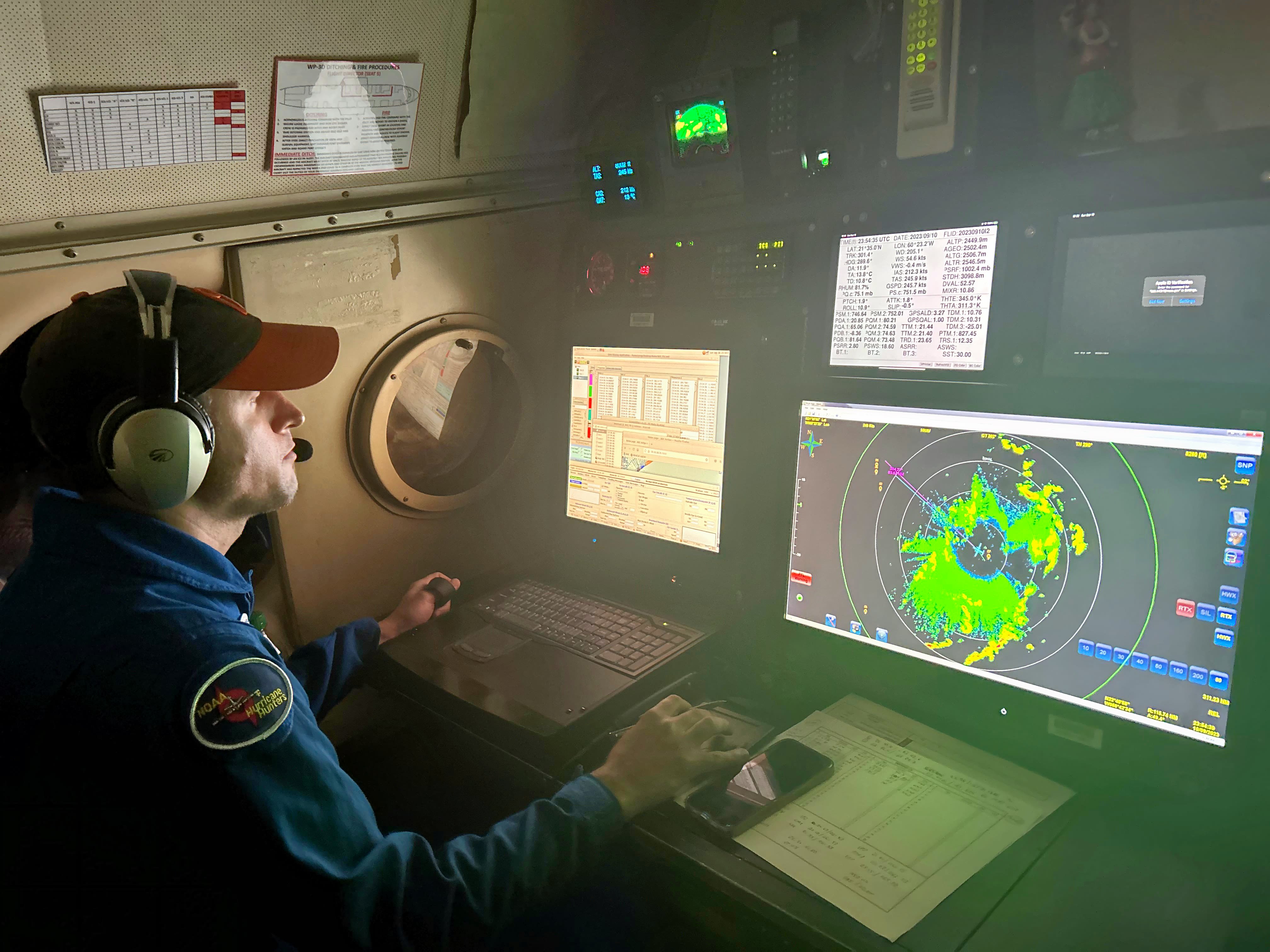 Flight Director Jonathan Zawislak inside hurricane hunter aircraft