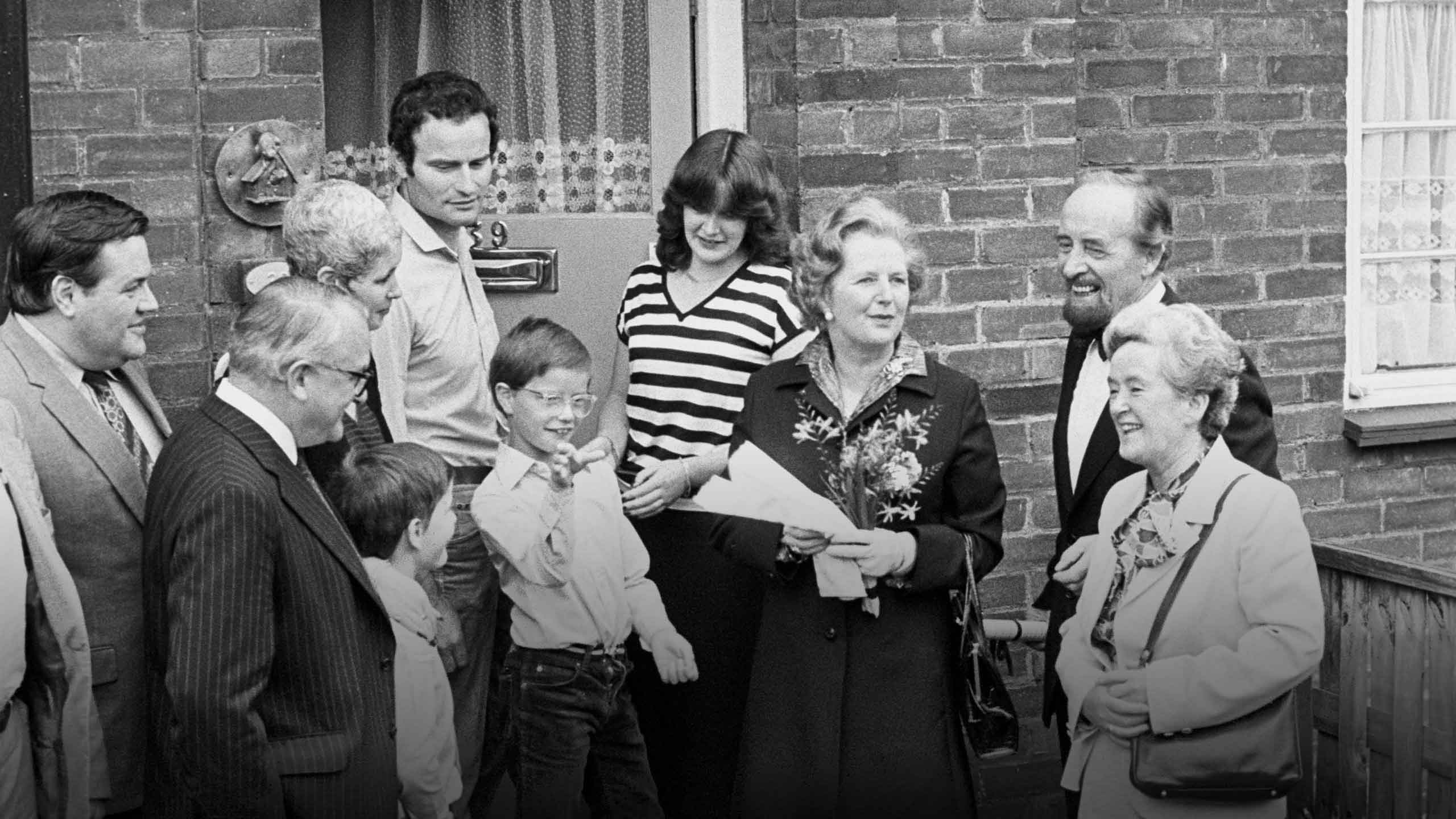 Prime Minister Margaret Thatcher, 3rd right, hands over a copy of the deeds of 39 Amersham Road, Harold Hill, in Essex, to James Patterson