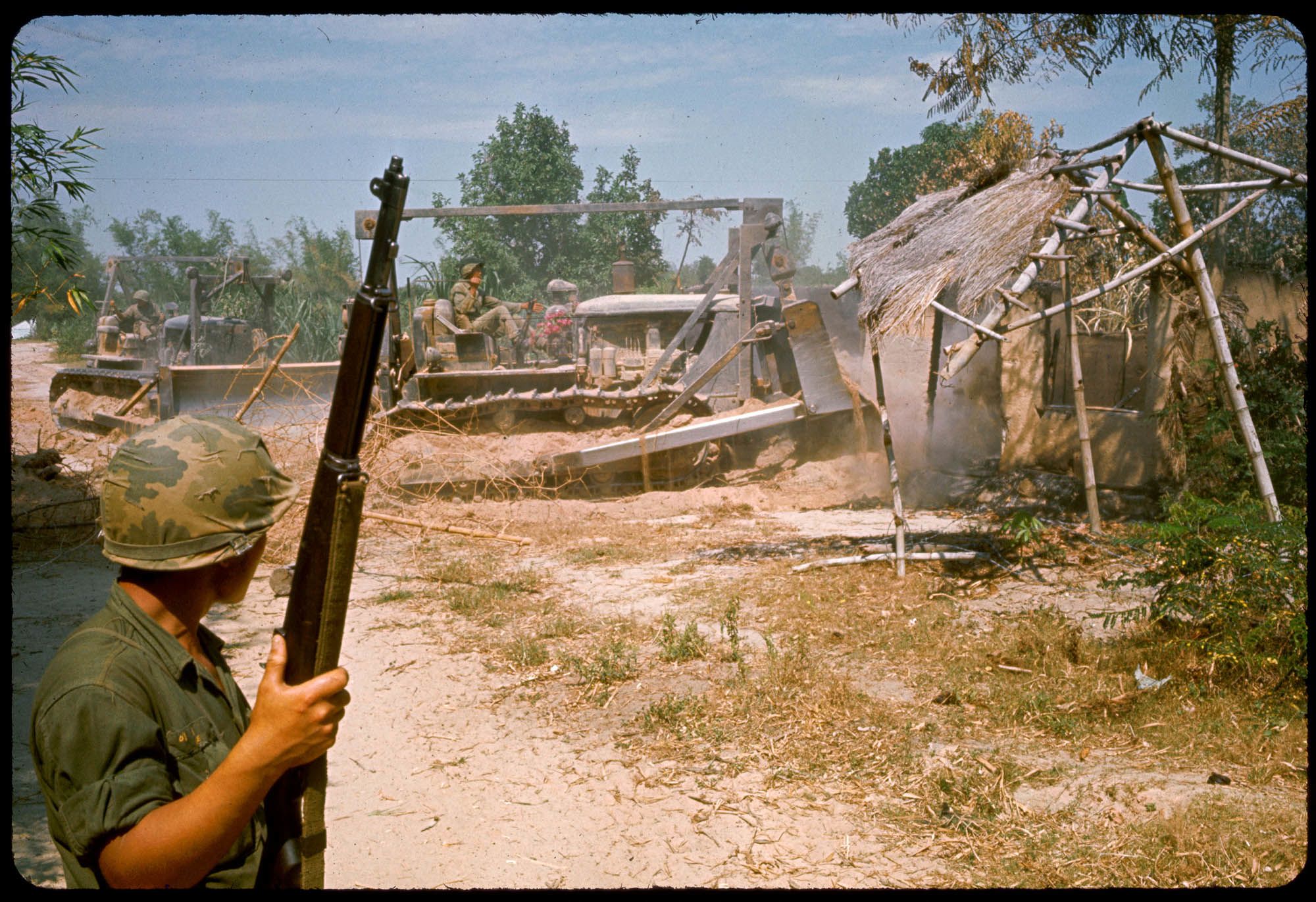 Korean soldiers bulldoze a Vietnamese village, north of Bong Sen
