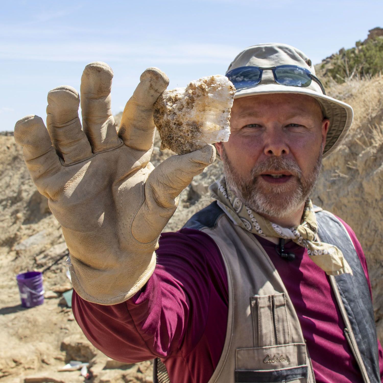 Phil holds up a fossil