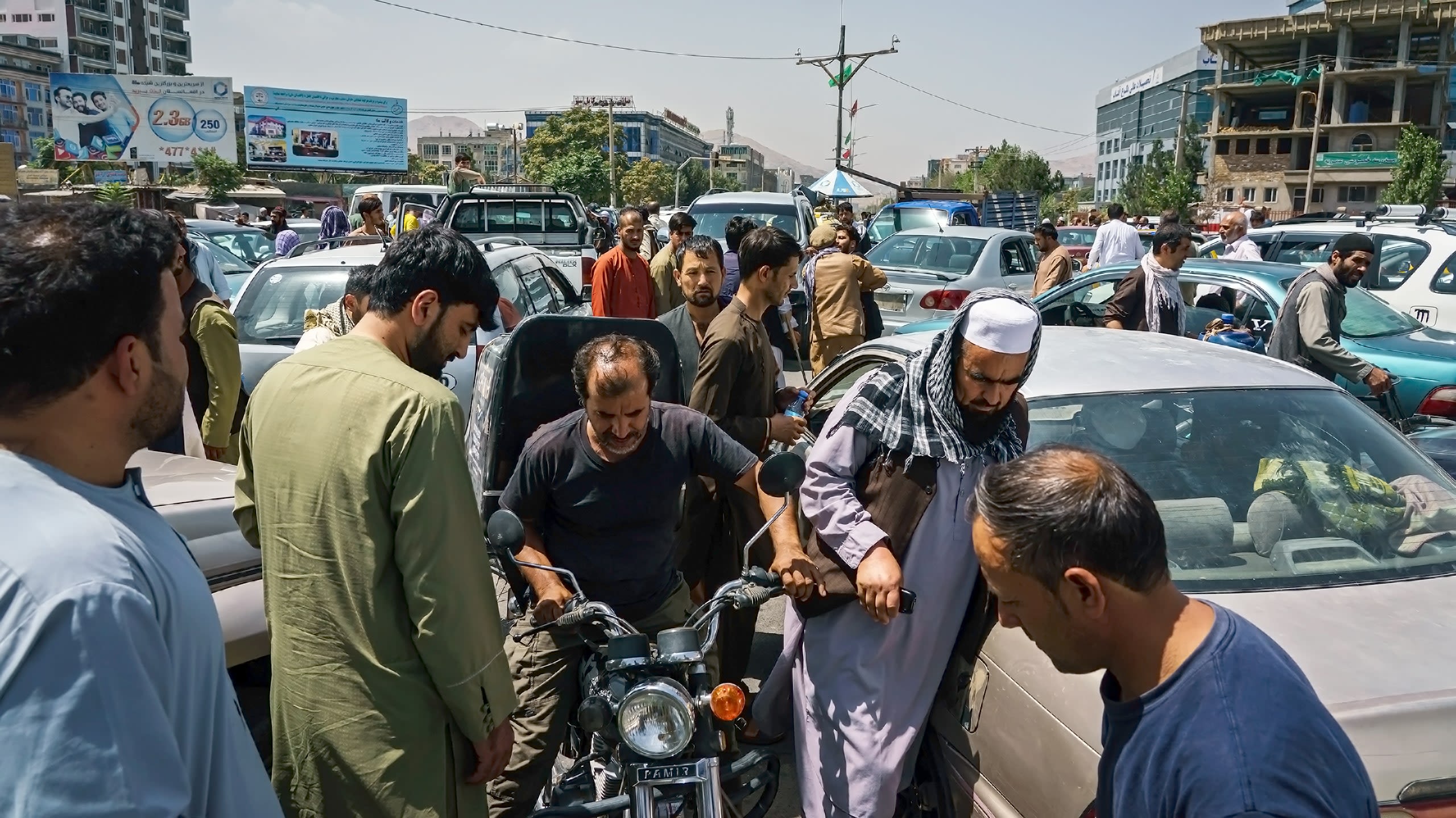 Pedestrians and motorists stuck in traffic gridlock as Afghans rush to safety amidst rumours of Taliban in the city on August 15 2021