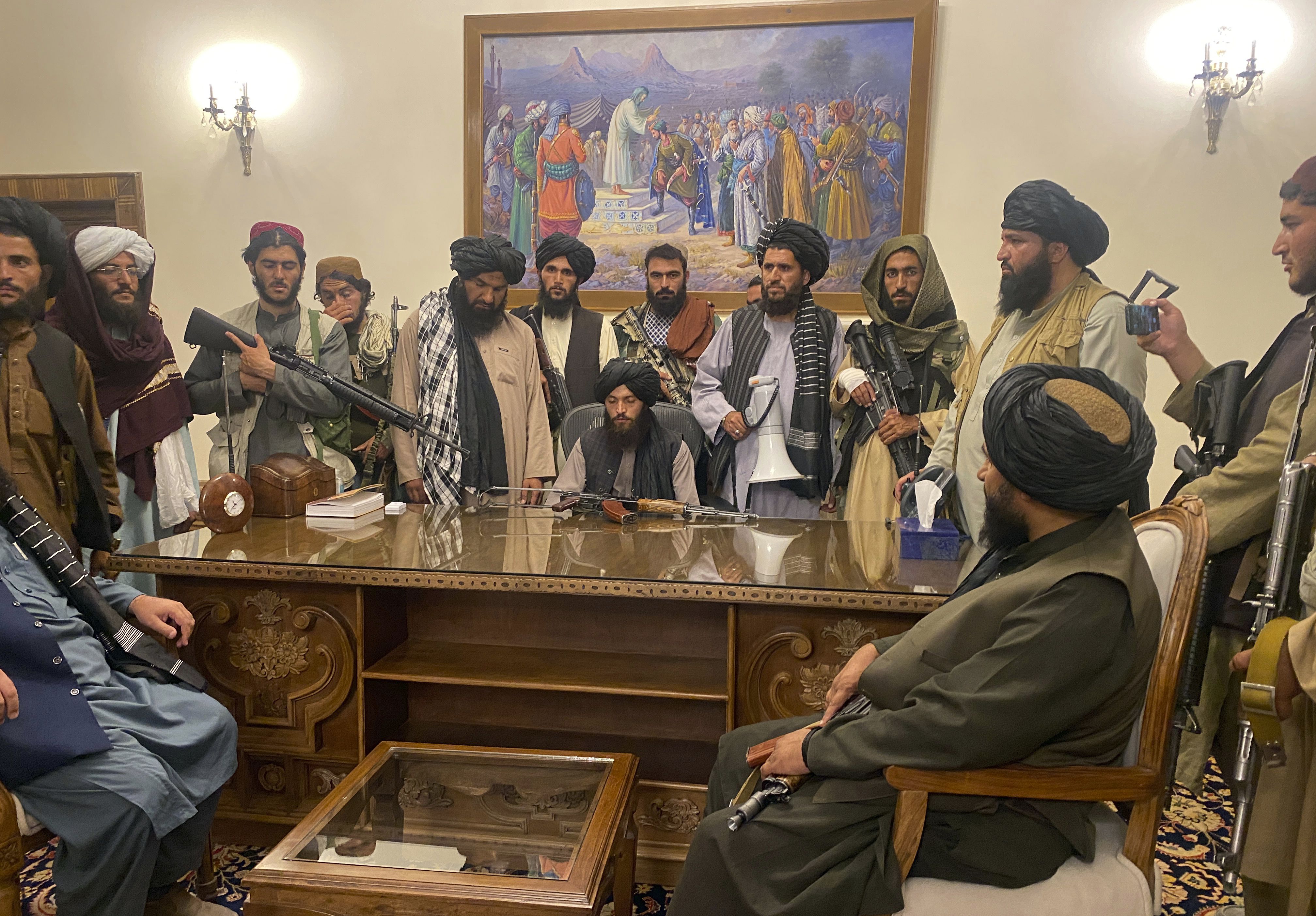 Taliban fighters inside the presidential palace in the evening of Sunday, 15 August 