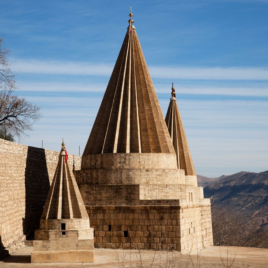 The iconic pointed spire of the Yazidis adorn the hills of the holy Yazidi temple of Lalish.