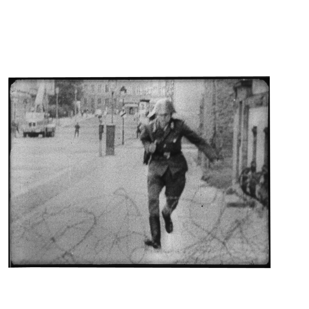 19-year-old, East German border guard Conrad Schumann jumps over barbed wire to West Berlin on 15 August 1961.