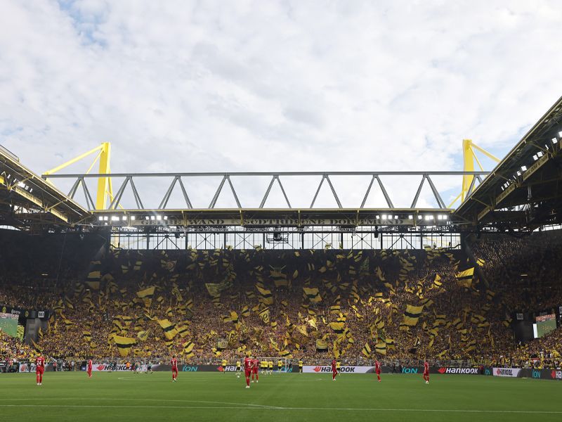 A view of flags being waved in Dortmund's famous "Yellow Wall"