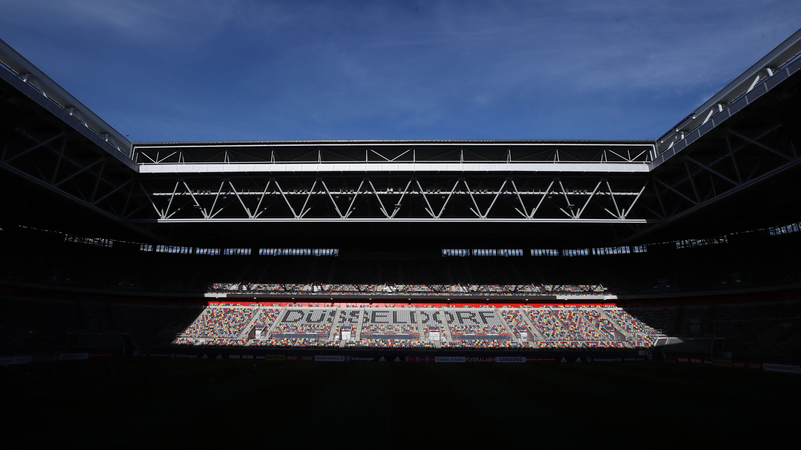 An interior view of Dusseldorf Arena with the sun picking out "Dusseldorf" in the seating