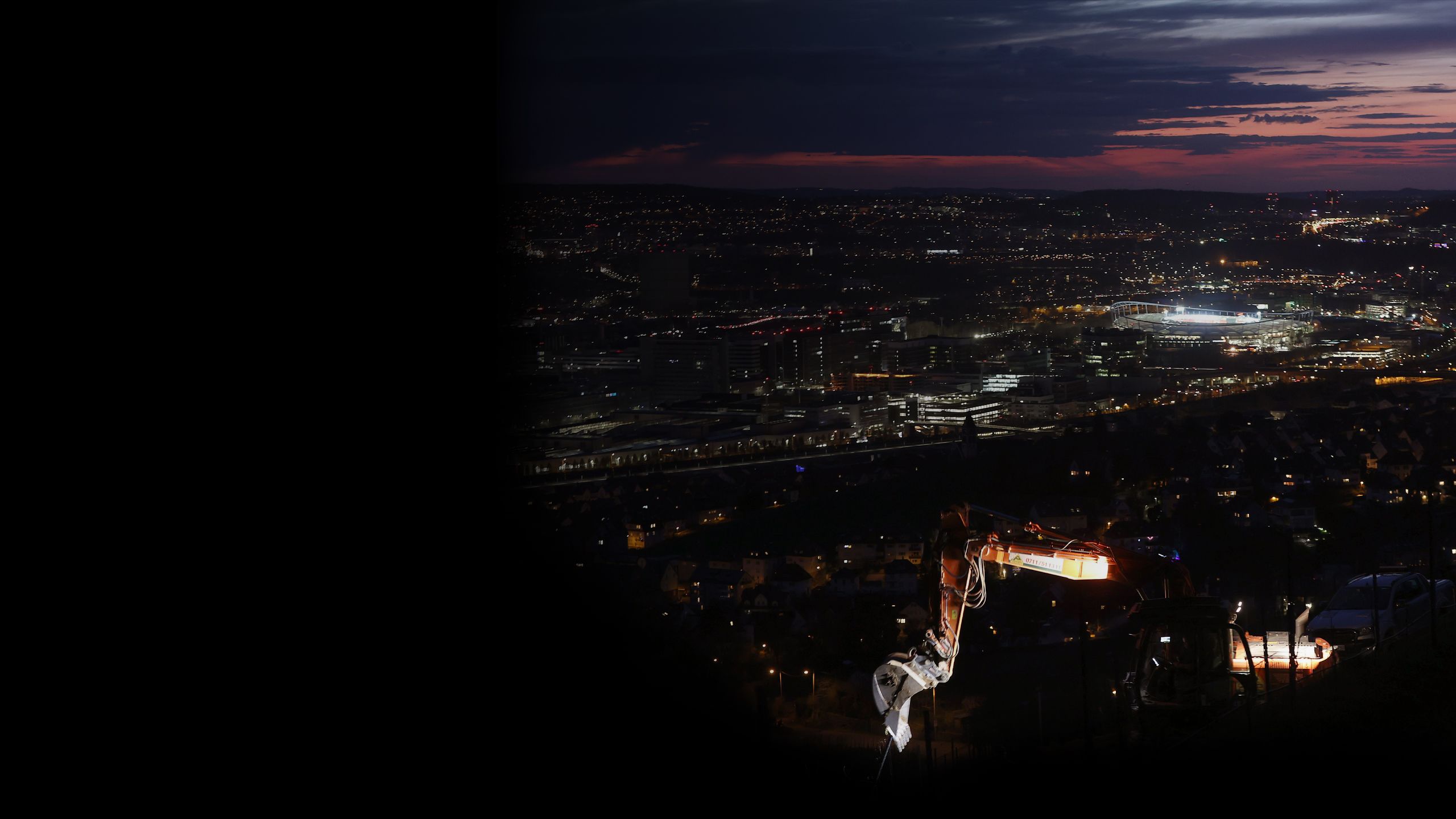 An exterior shot of the Stuttgart Arena at night