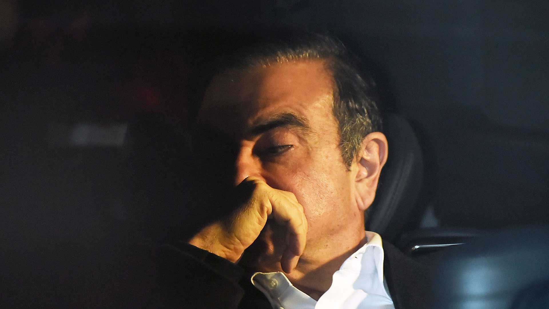 Ghosn looks pensively into the distance