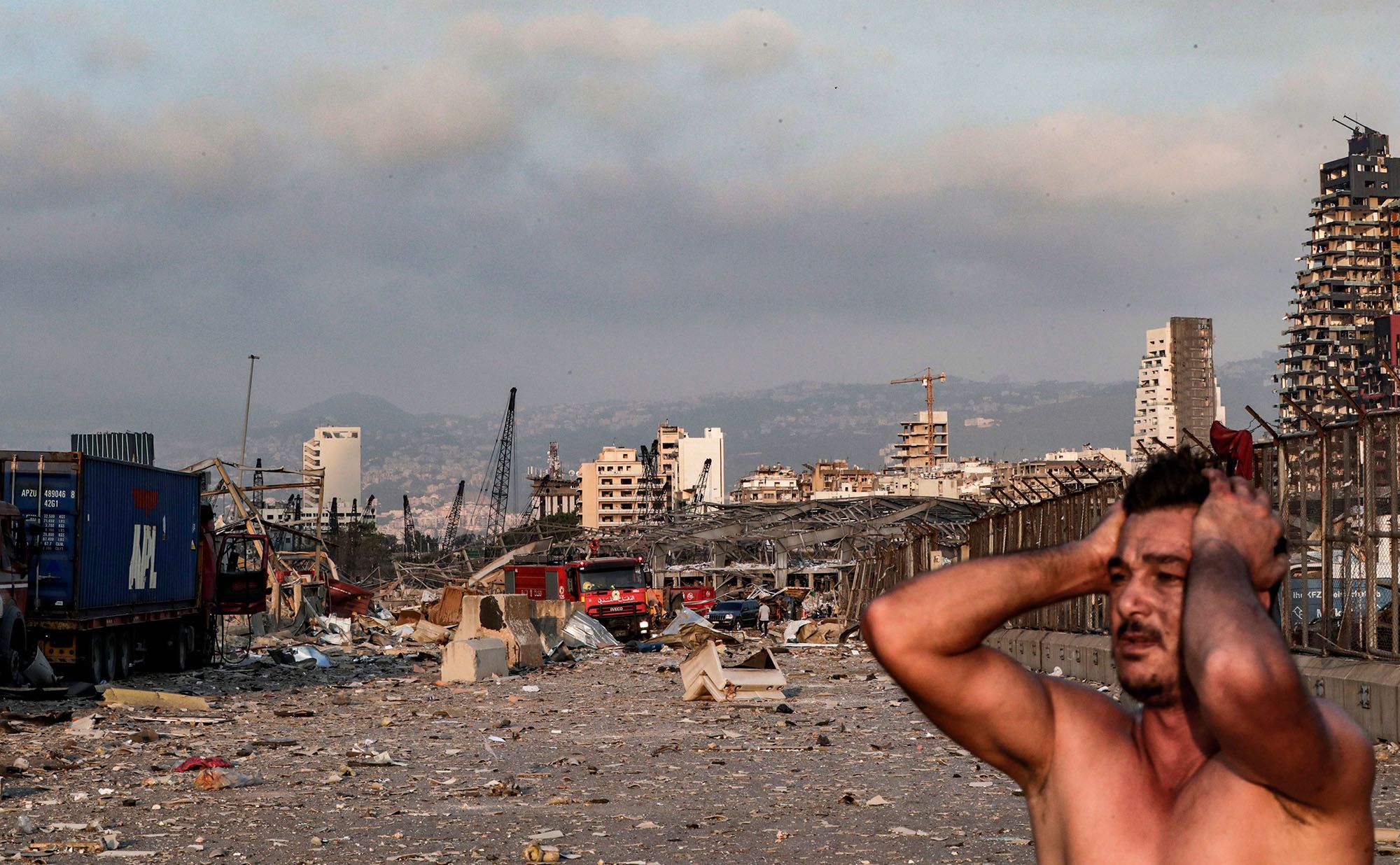 A man reacts at the scene of an explosion at the port in Beirut