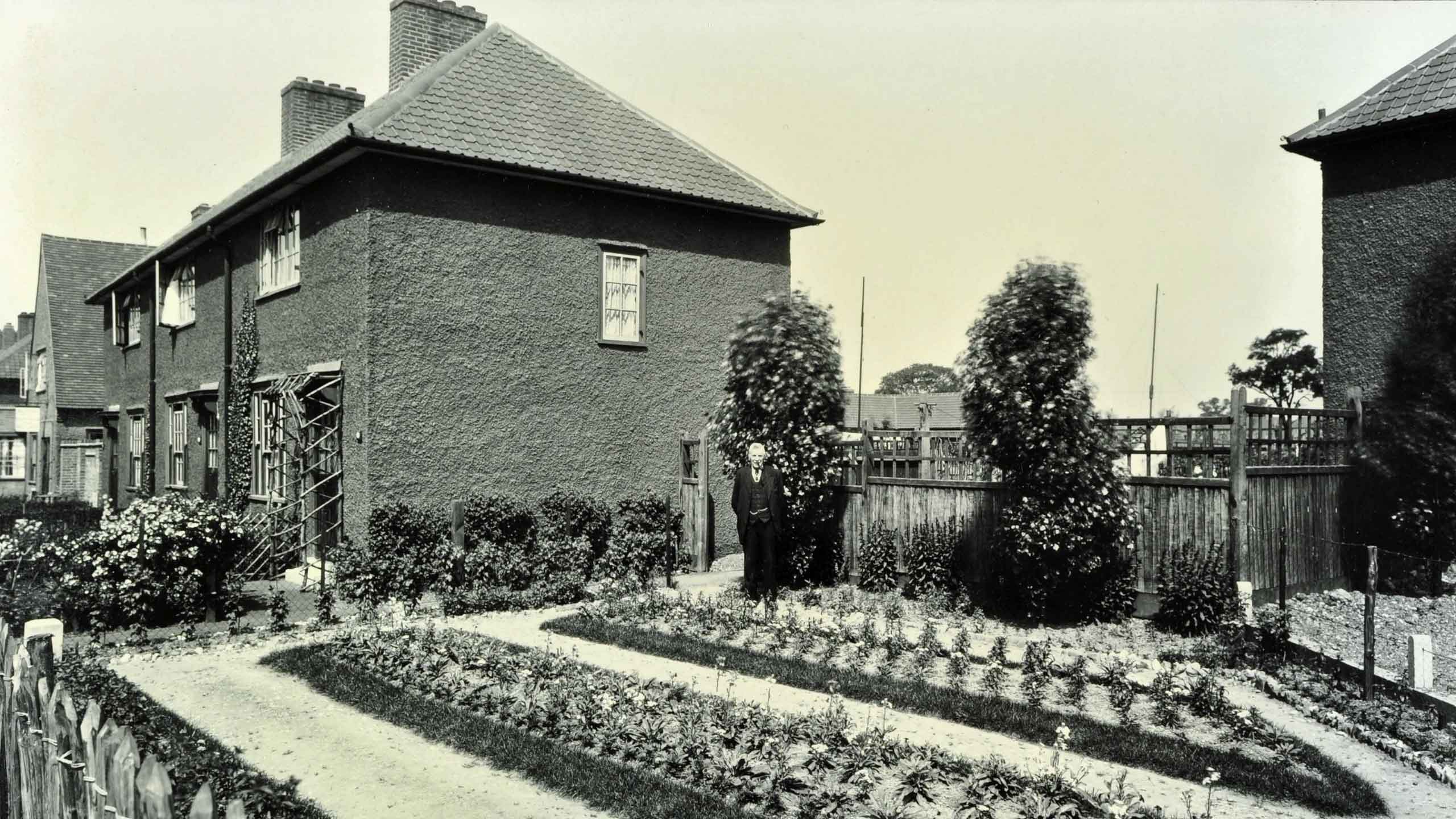 Man stands in the garden of his Becontree council house, 1929