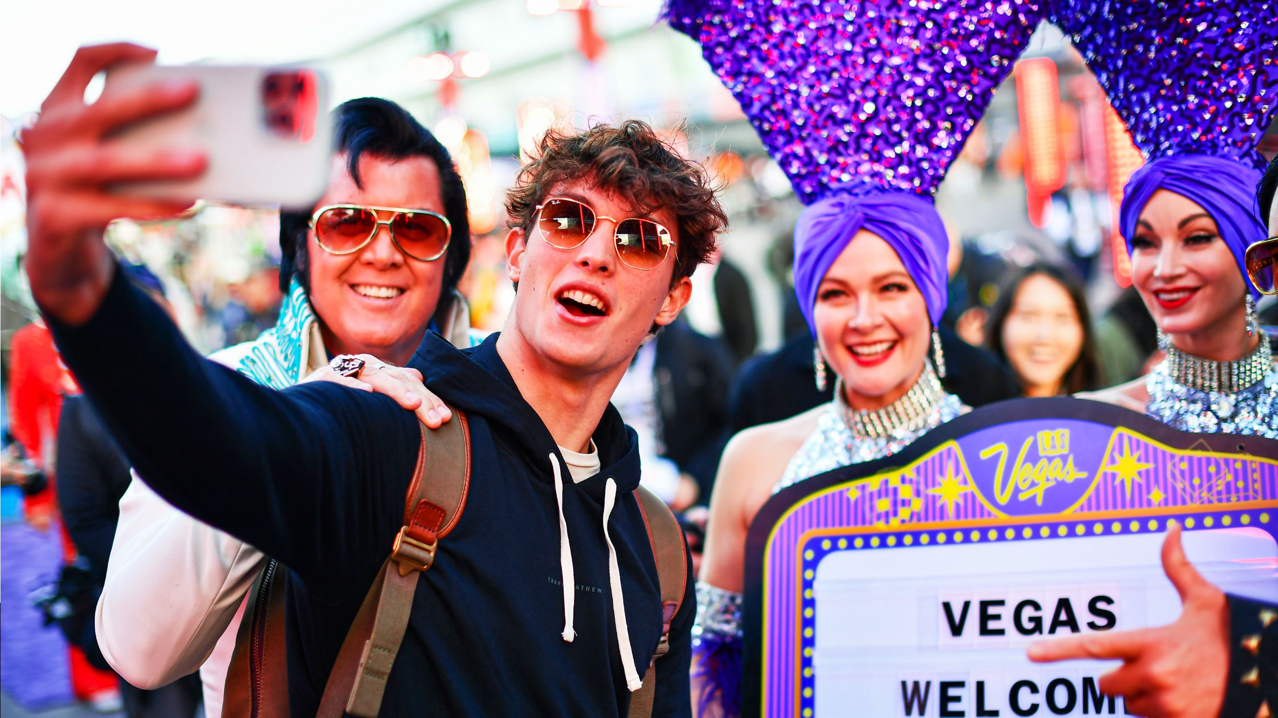 Aerial view of the Australian Grand Prix circuit at Albert Park in Melbourne, with the race track running alongside the lake and the city skyline featuring modern skyscrapers in the background.