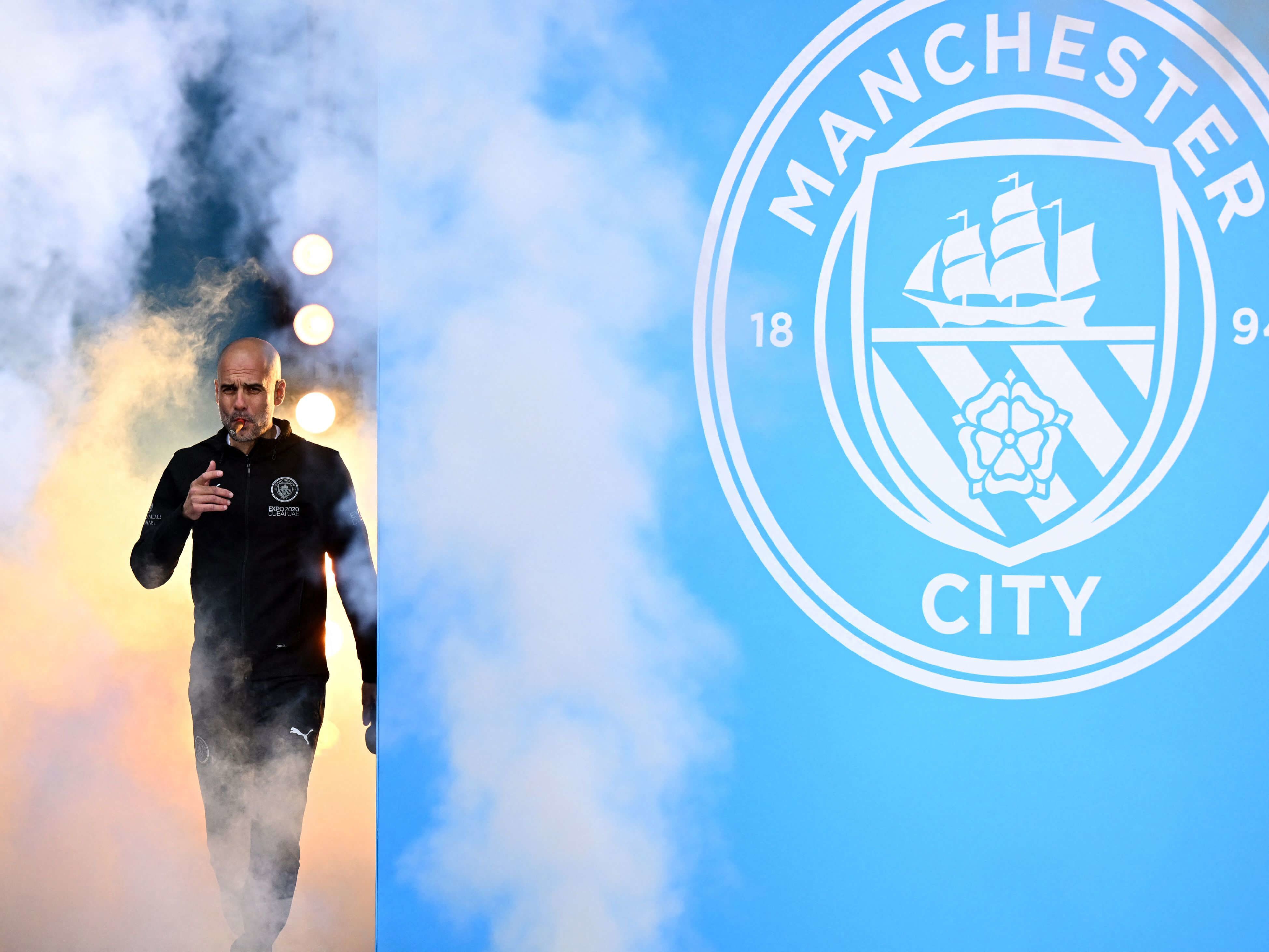 Manchester City manager Pep Guardiola smokes a cigar during celebrations for the club's title win in 2022