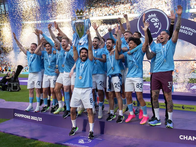 Ilkay Gundogan (centre) holds aloft the Premier League trophy surrounded by team-mates in 2023