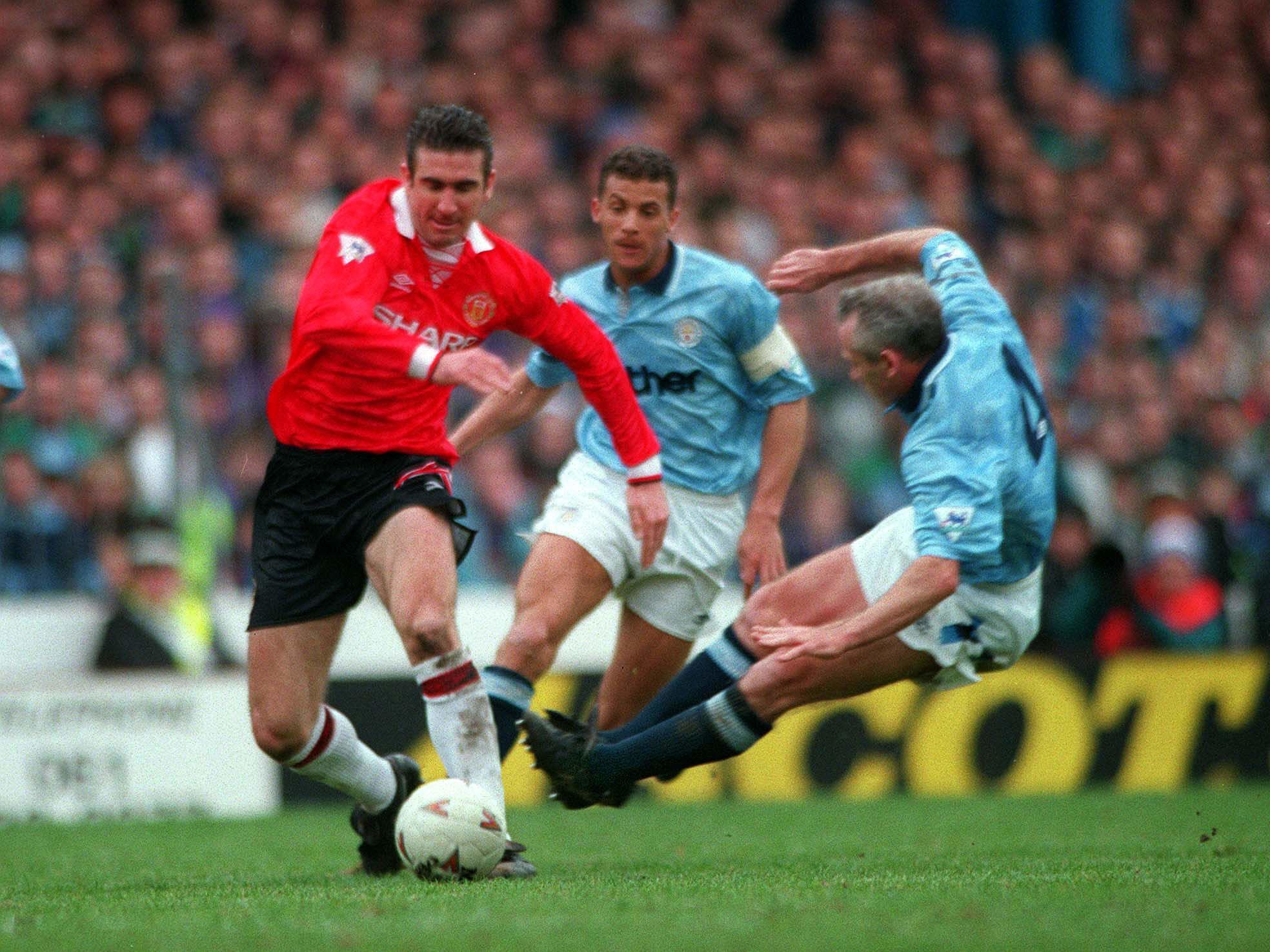City's Peter Reid flies in to tackle Eric Cantona in a Manchester derby in 1993