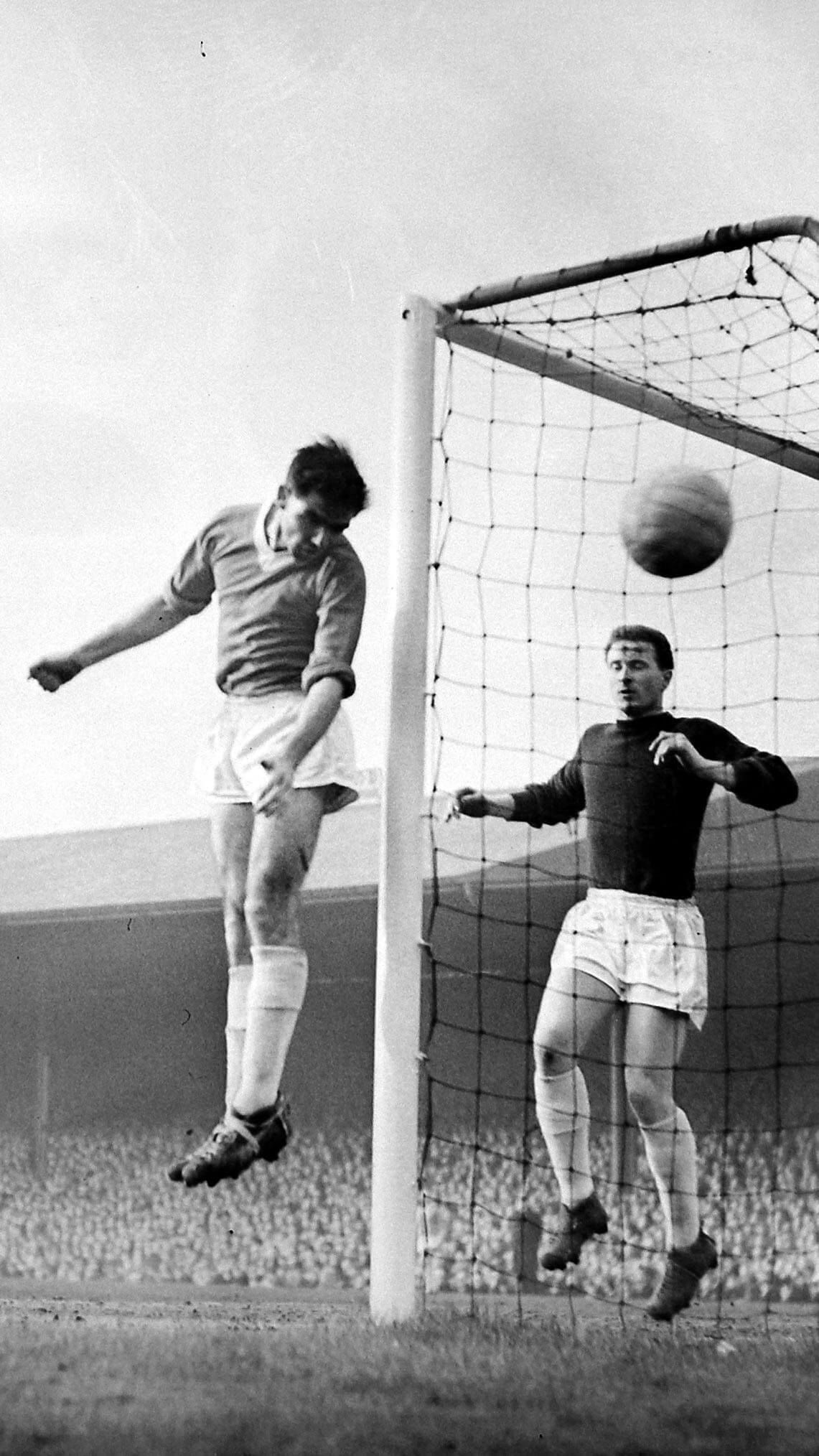 United goalkeeper Harry Gregg is lucky to keep his goal intact in the first half. Here Joe Carolan of Manchester City heads wide of the goal heads wide with Gregg behind on 6th February 1960