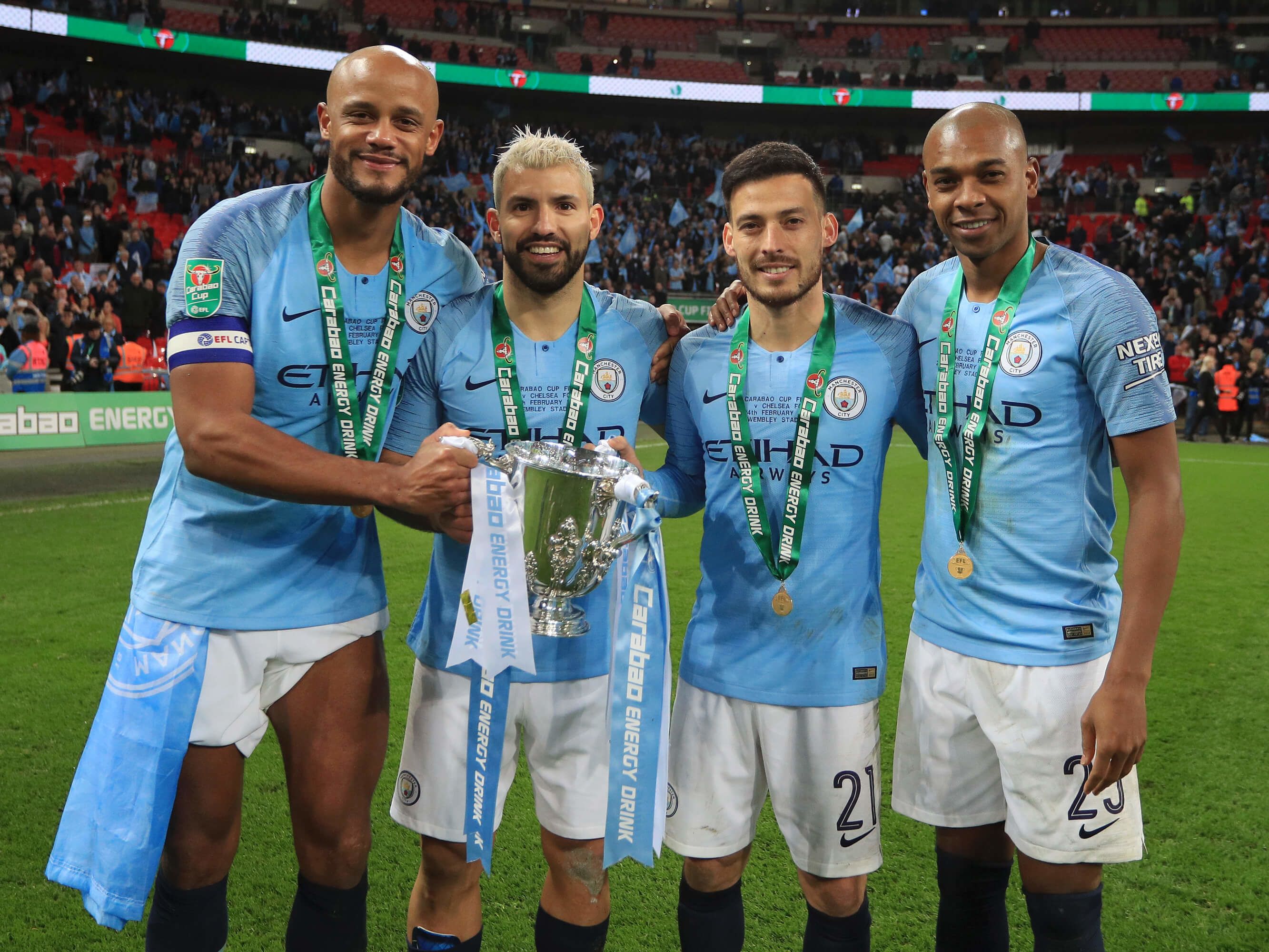 Vincent Kompany, Sergio Aguero, David Silva and Fernandinho pose with the Carabao Cup in 2019