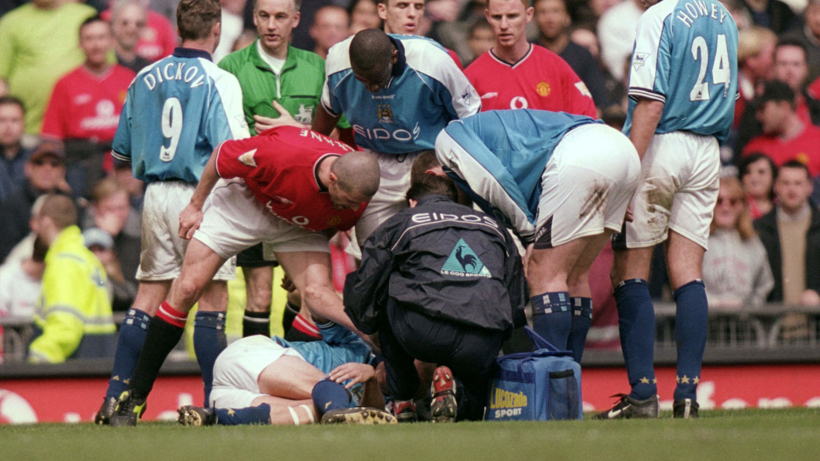 Roy Keane leans over Alf-Inge Haaland after fouling him in the Manchester derby in 2001
