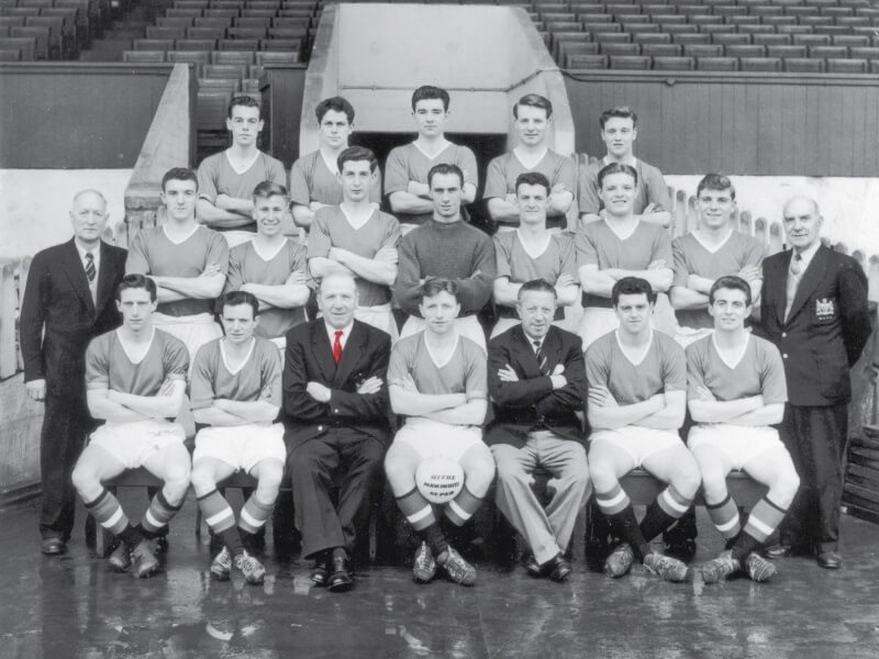 The Manchester United squad 1957 (back row, left to right) Colin Webster, Wilf McGuinness, Jackie Blanchflower, John Doherty, Eddie Coleman, (middle row) trainer Tom Curry, Bill Foulkes, Bobby Charlton, Freddie Goodwin, Ray Wood, Bill Whelan, Mark Jones, Duncan Edwards, assistant trainer W Inglis, (front row) Dennis Viollet, John Berry, manager Matt Busby, captain Roger Byrne, assistant manager Jimmy Murphy, Tommy Taylor, David Pegg.