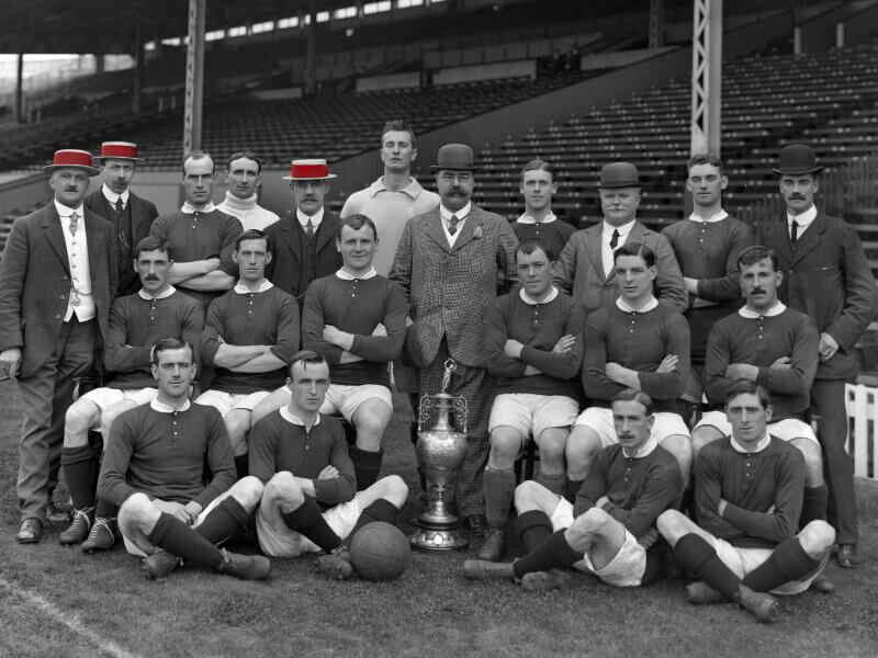 Manchester United - Winners of the League Division One Championship trophy 1907-1908. Also winners of the first Charity Shield game in 1908 beating Queens Park Rangers. Back (left to right): Ernest Mangnall (Secretary/Manager) F Bacon (trainer) Jack Picken, Hugh Edmonds, Mr Murray (director) Harry Moger, John Henry Davies (Chairman) Tom Homer, Mr Lawton (director) Alex Bell, Mr Deakin (director) Middle: Billy Meredith, Richard Duckworth, Charlie Roberts, Sandy Turnbull, Enoch West, George Stacey. Sat: Arthur Whalley, Leslie Horton, Harold Halse, George Wall