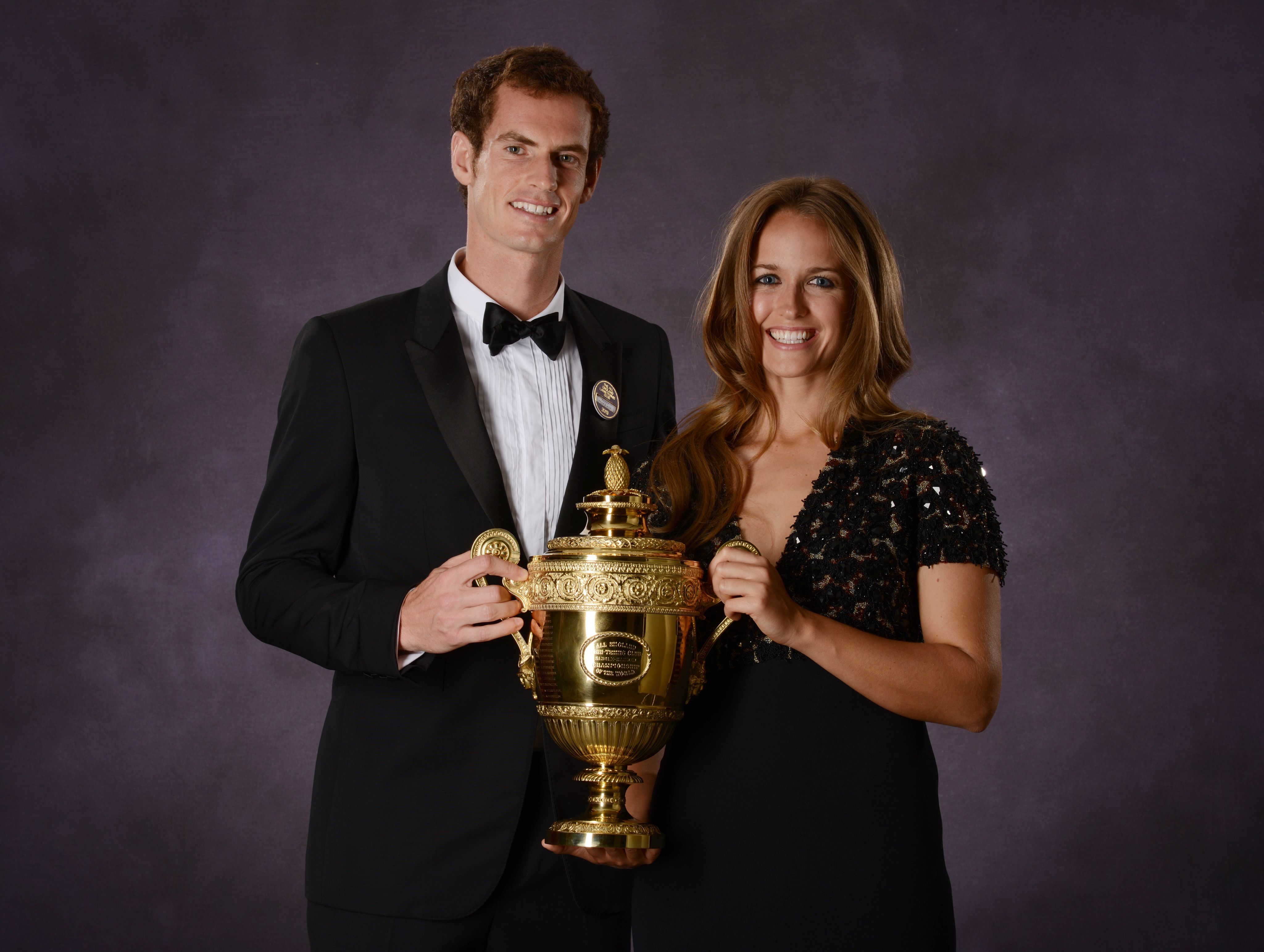 Andy Murray and his girlfriend Kim Sears hold the trophy at the Champions' Dinner in 2013