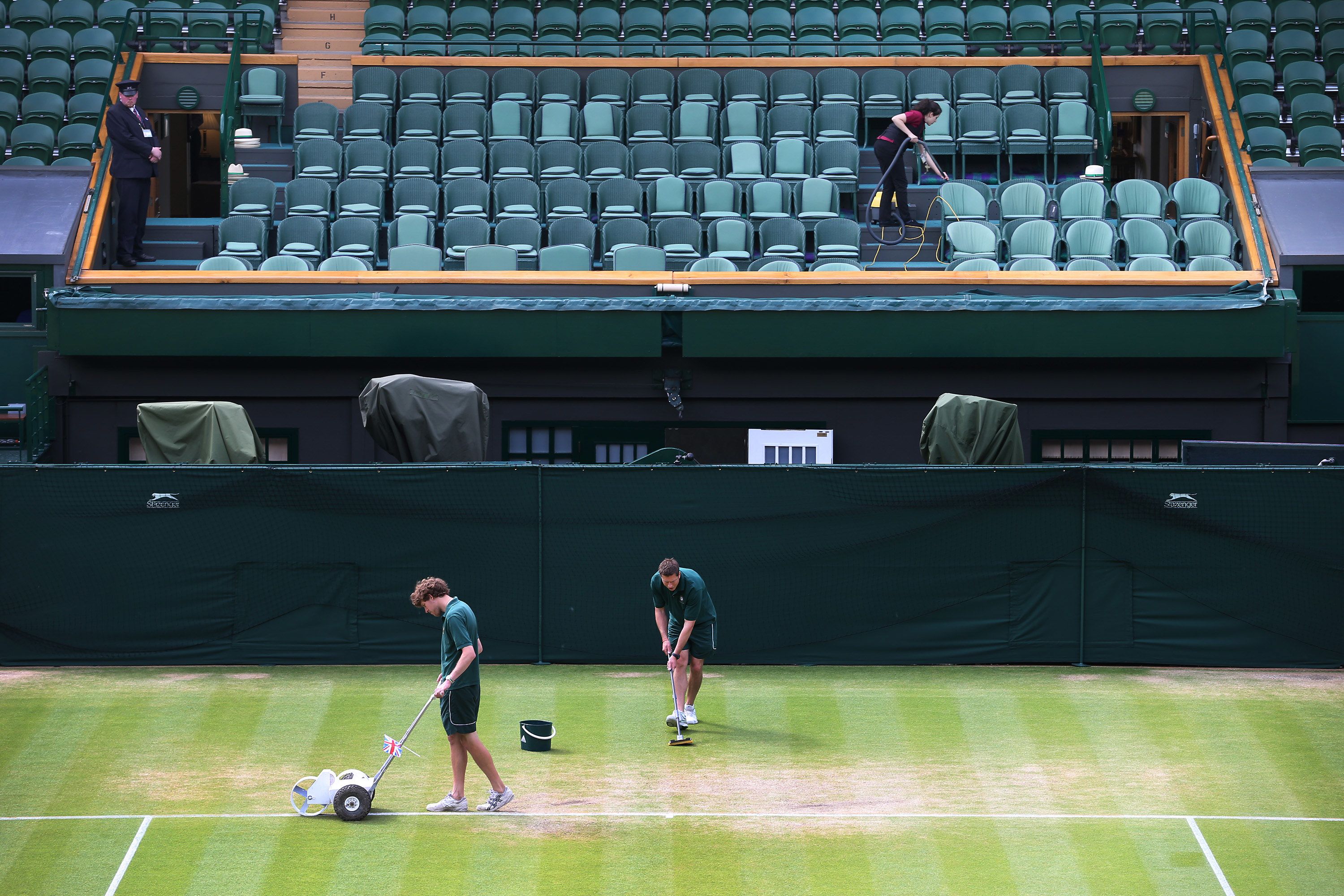 Wimbledon groundstaff prepare the Centre Court baseline 