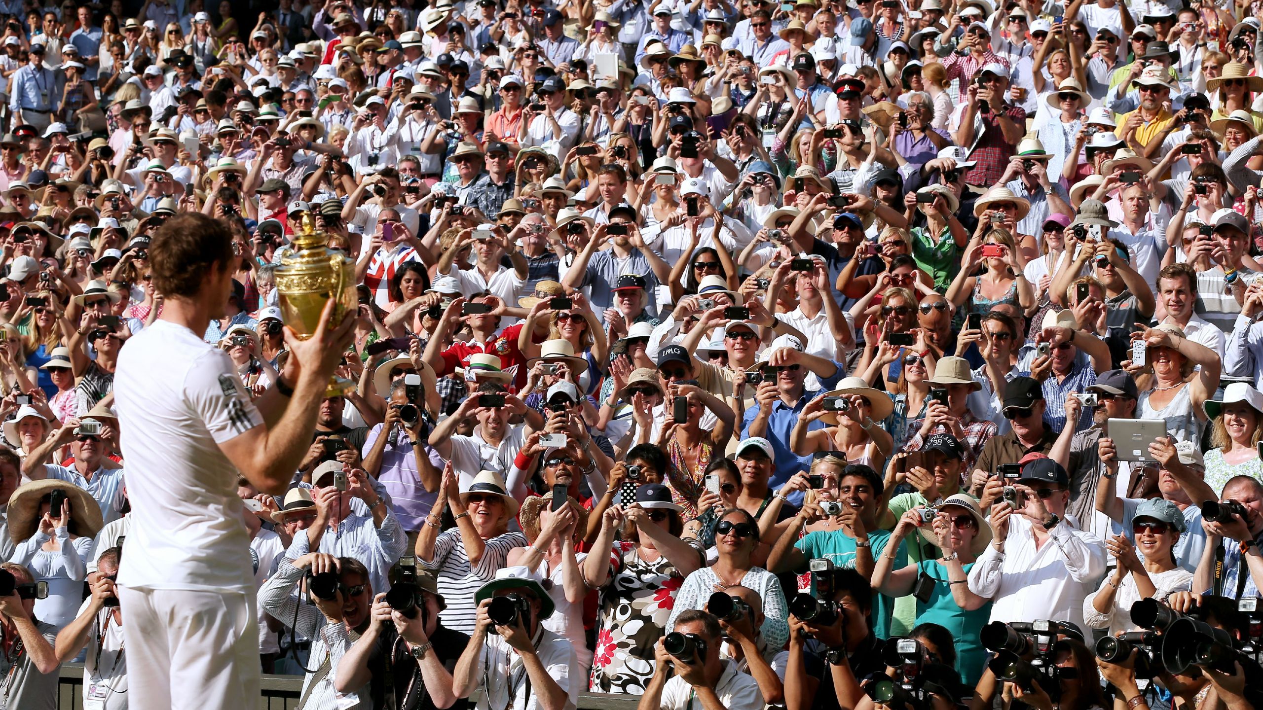 Andy Murray holds up the Wimbledon trophy to the crowd