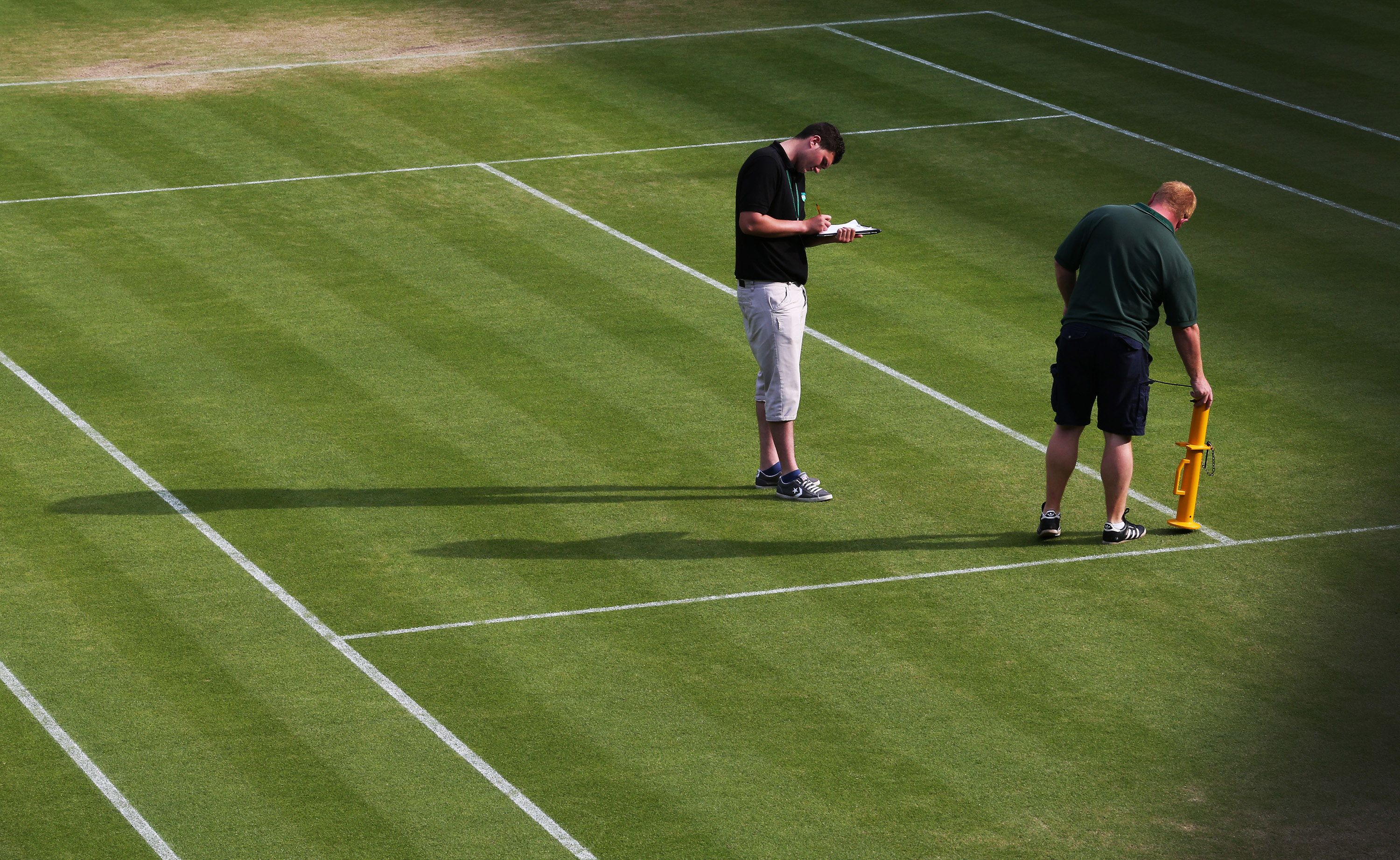 HawkEye staff prepare and test the technology before the 2013 Wimbledon men's final