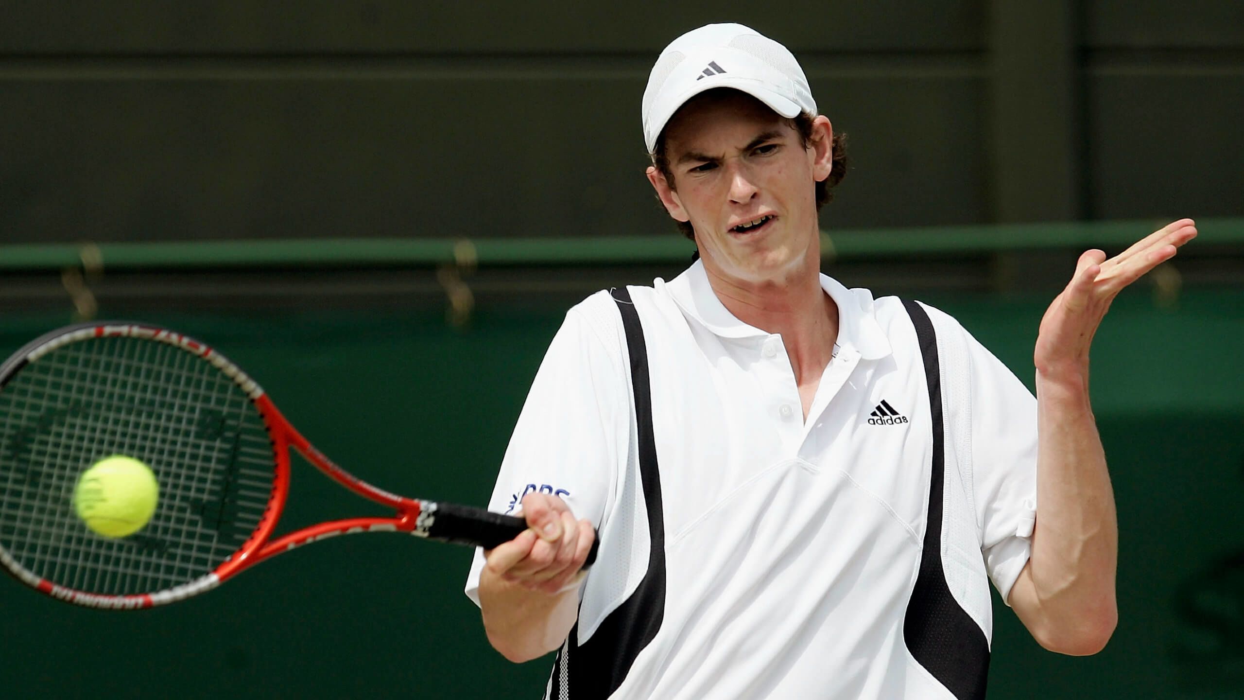 Andy Murray returns with a forehand during a Wimbledon boys' singles match in 2004