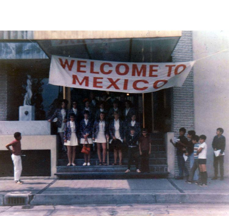 England players standing on their hotel steps under a Welcome To Mexico banner