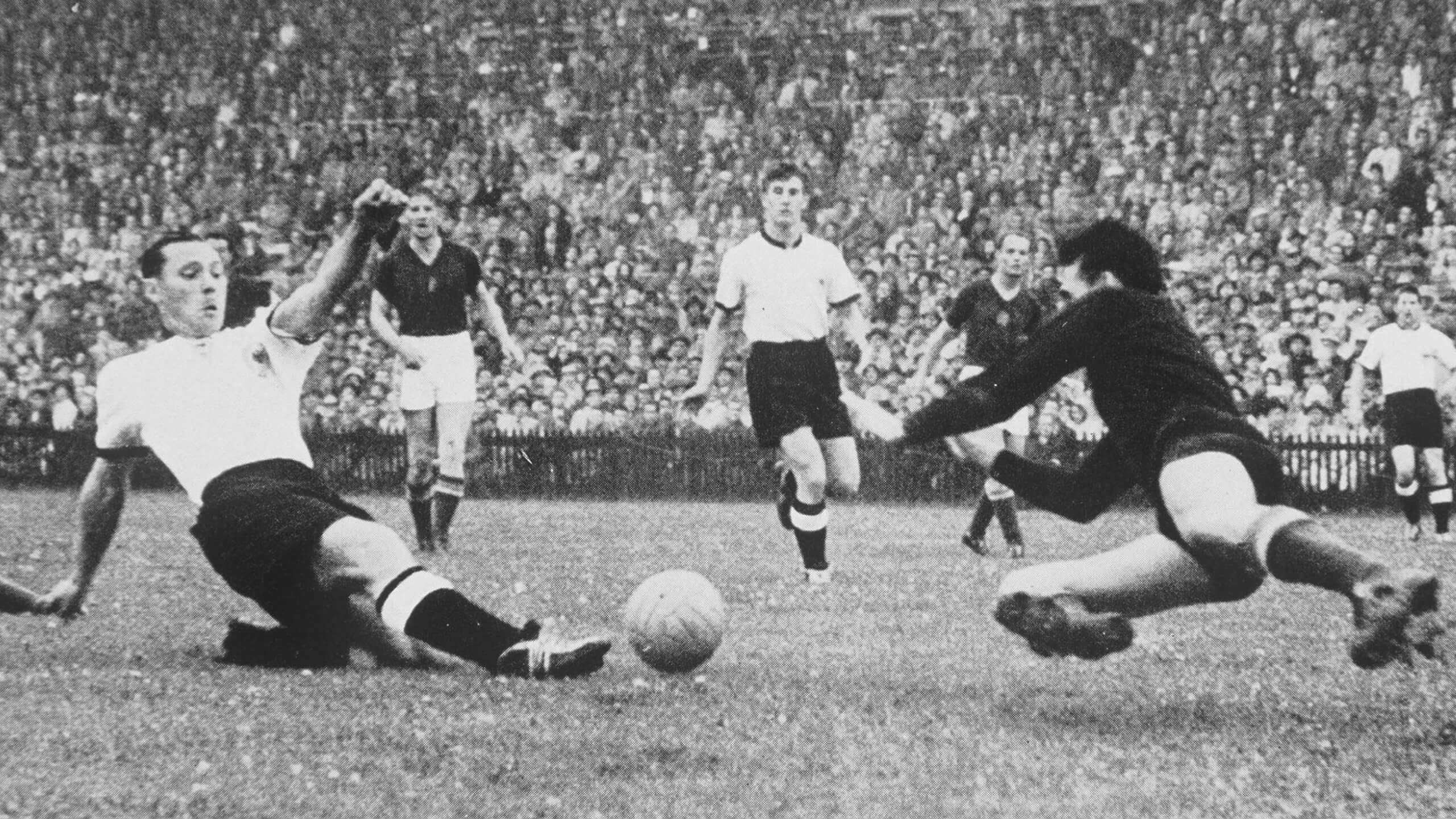 West Germany's Max Morlock slides home his side's first goal past Hungarian goalkeeper Grosics to start their comeback in the 1954 World Cup final