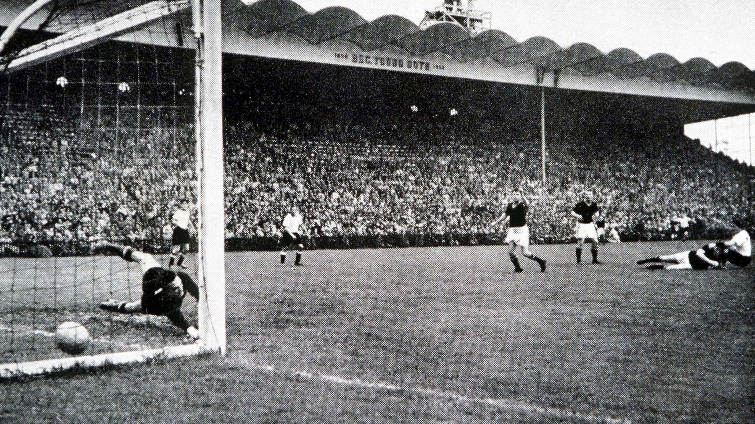 Hungary's goalkeeper Gyula Grosics is beaten as West German Helmut Rahn has scored the winning goal in the 1954 World Cup final