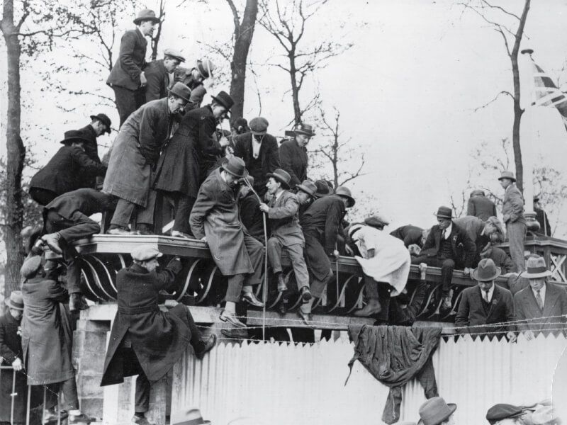 Fans scale the walls to gain access to the stadium at Wembley ahead of the 1923 FA Cup final