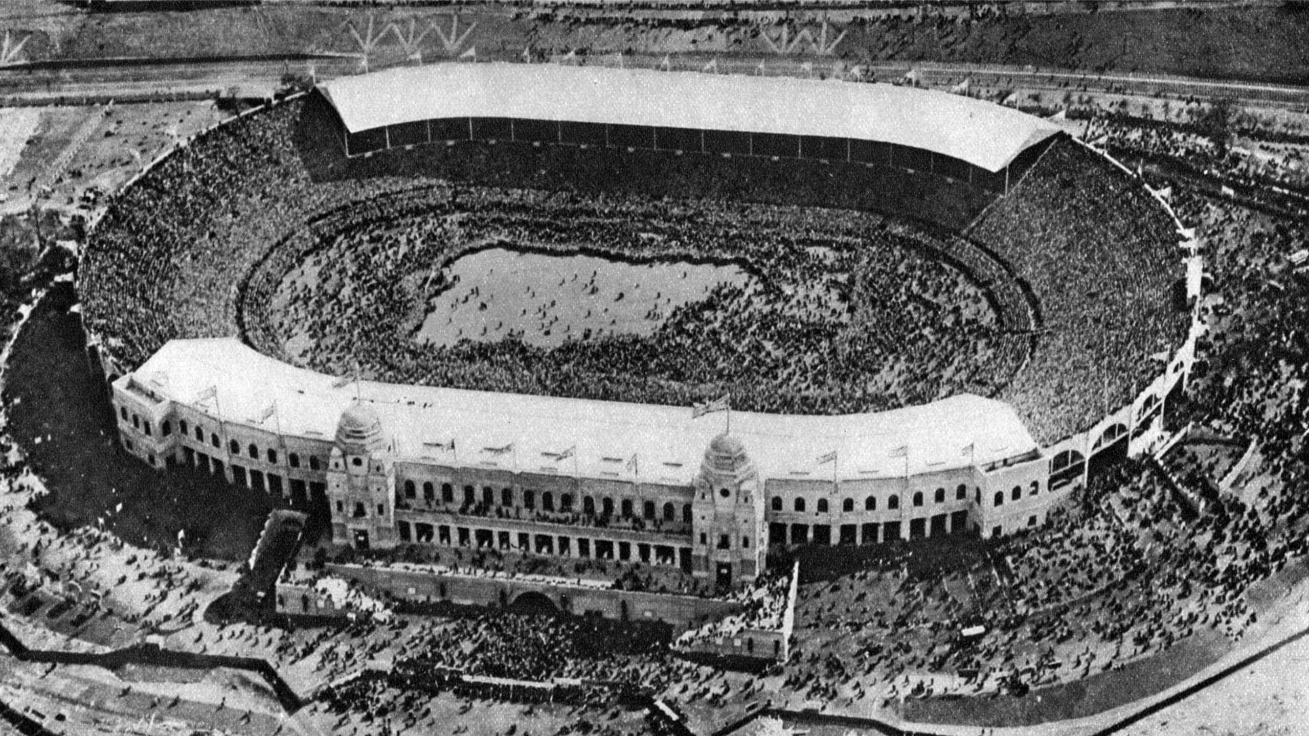 An aerial view of Wembley shows thousands of fans on the pitch ahead of the 1923 FA Cup final