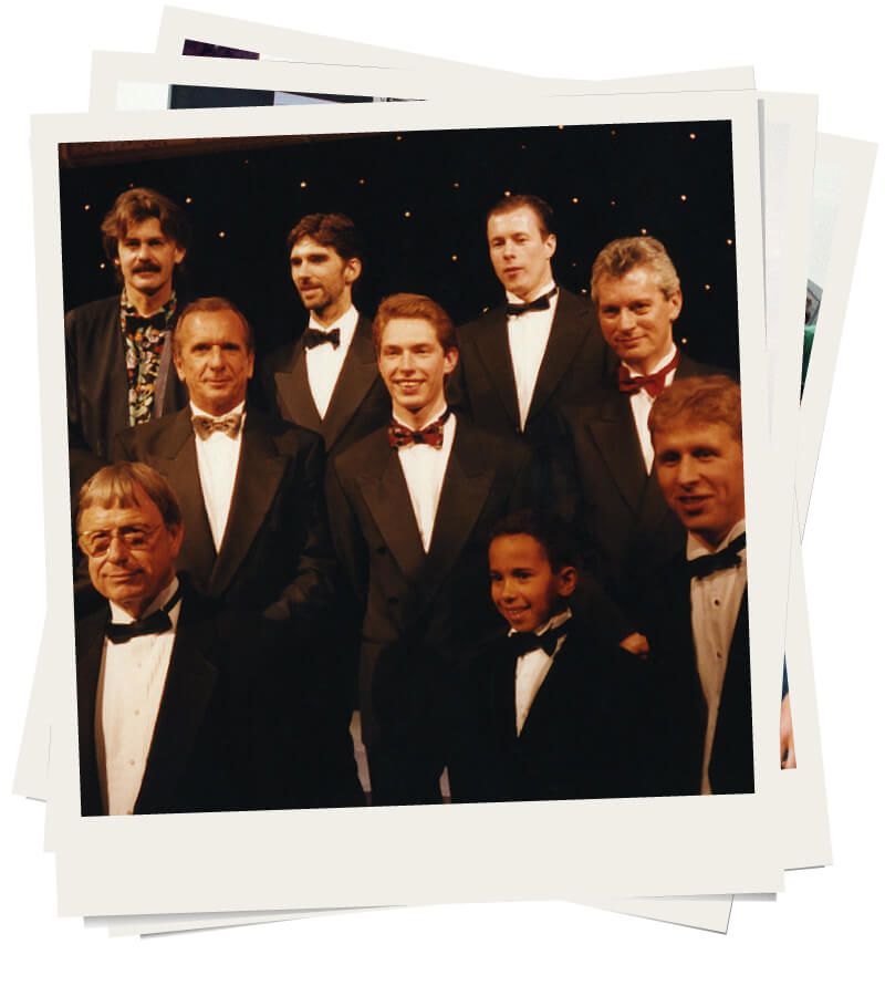 Young Lewis Hamilton surrounded by F1 individuals at the 1995 Autosport awards