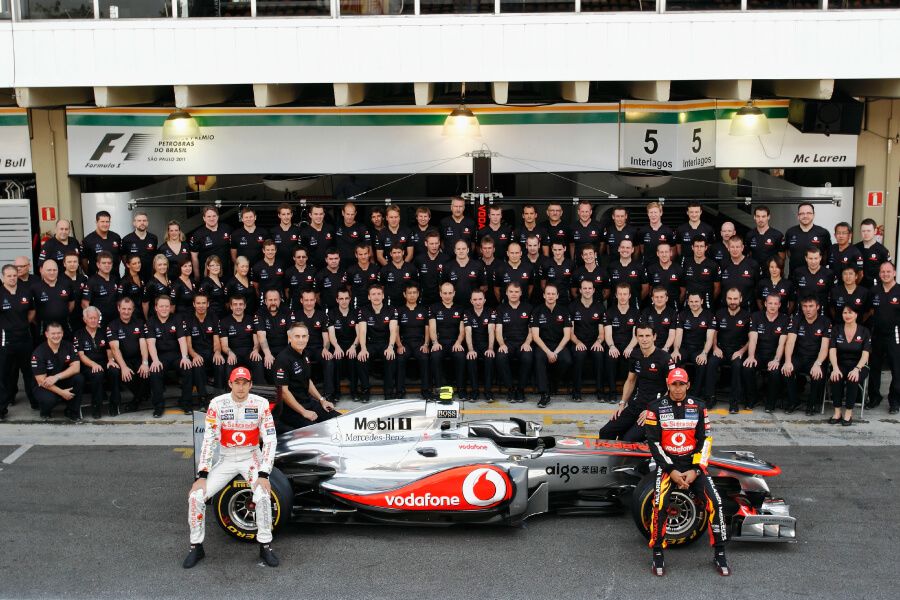 Lewis Hamilton (front, right) with the rest of the McLaren team in Brazil in 2011