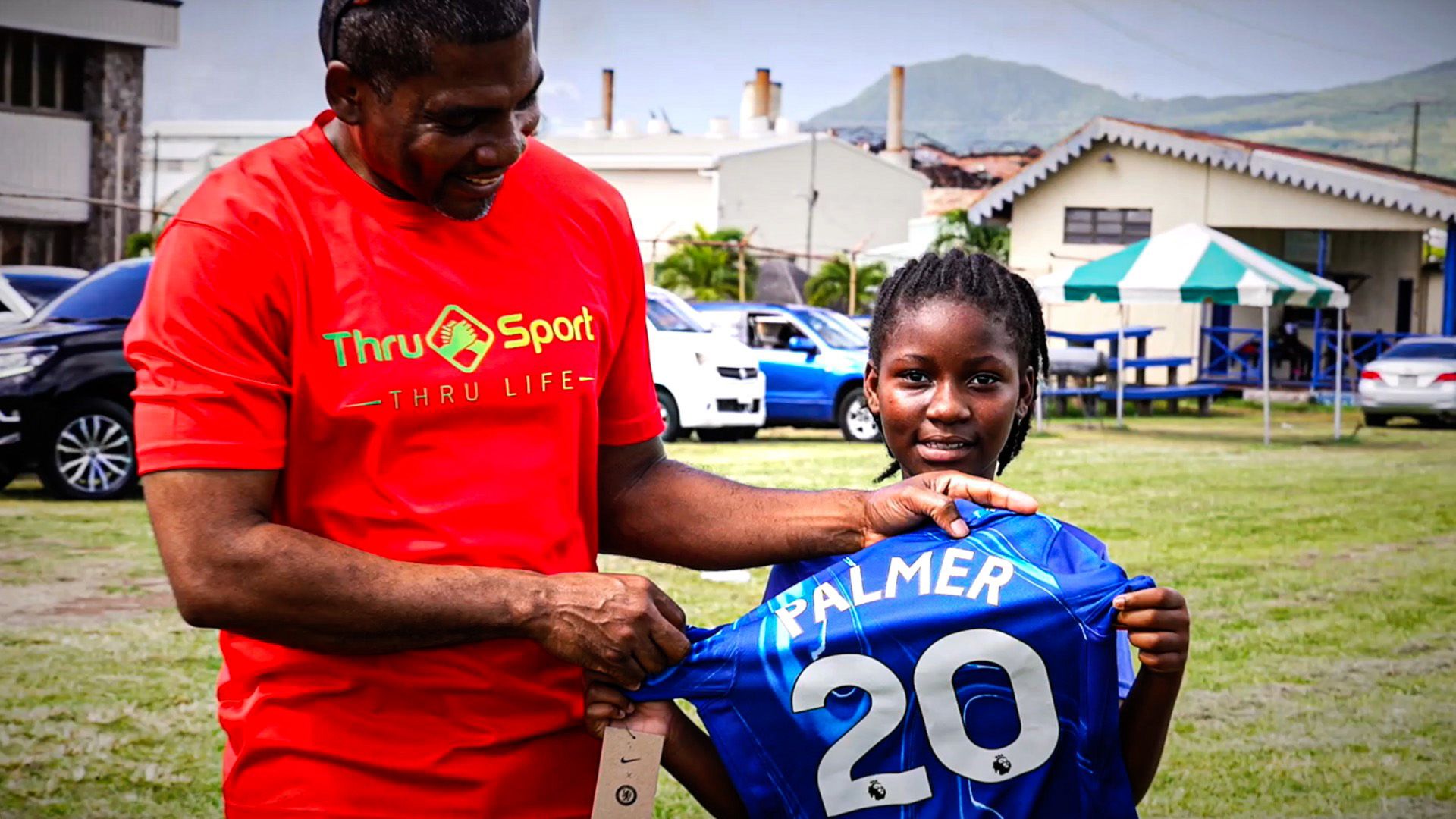 St Kitts president with a schoolgirl holding a Chelsea shirt with Cole Palmers name on
