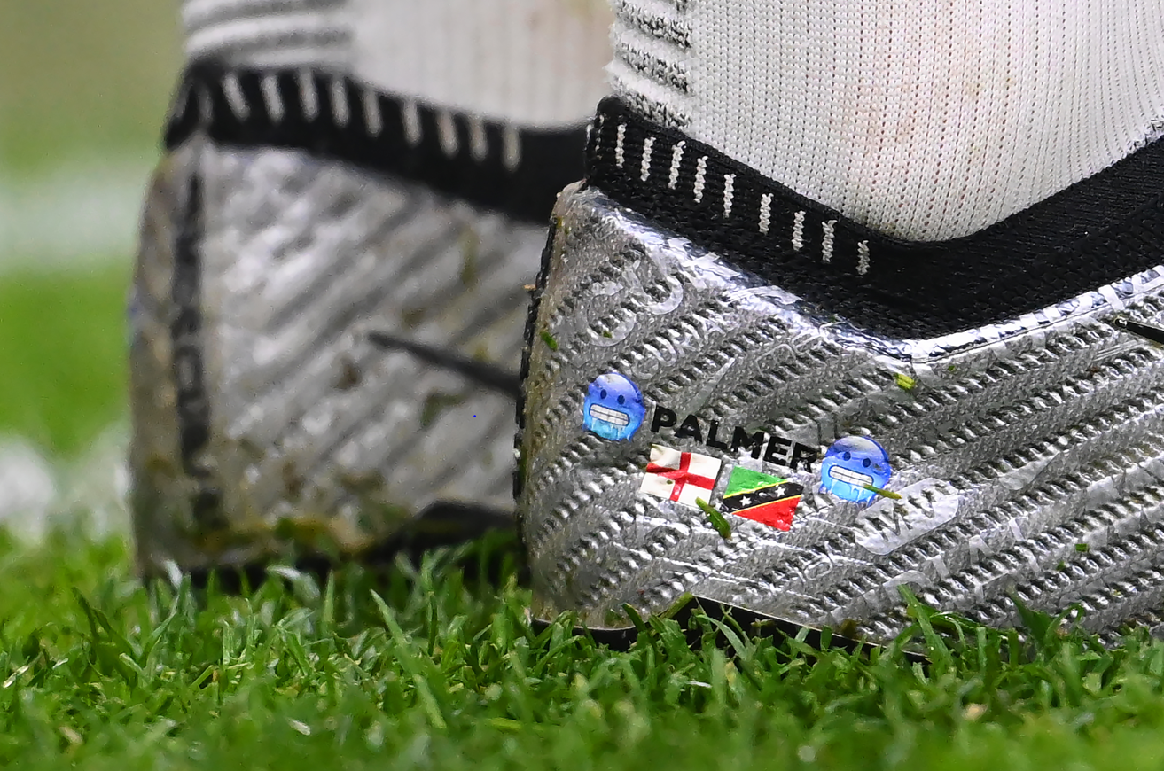 Close up photograph of Cole Palmers football boots which bare the flags of England and St Kitts on