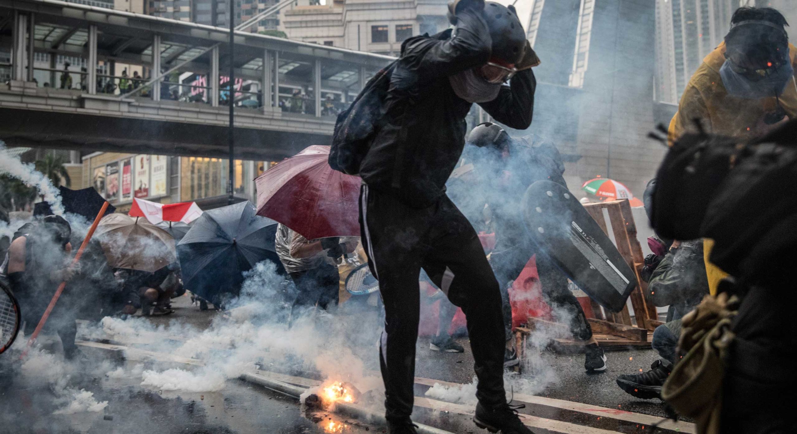 Protesters brace as tear gas canisters rain down