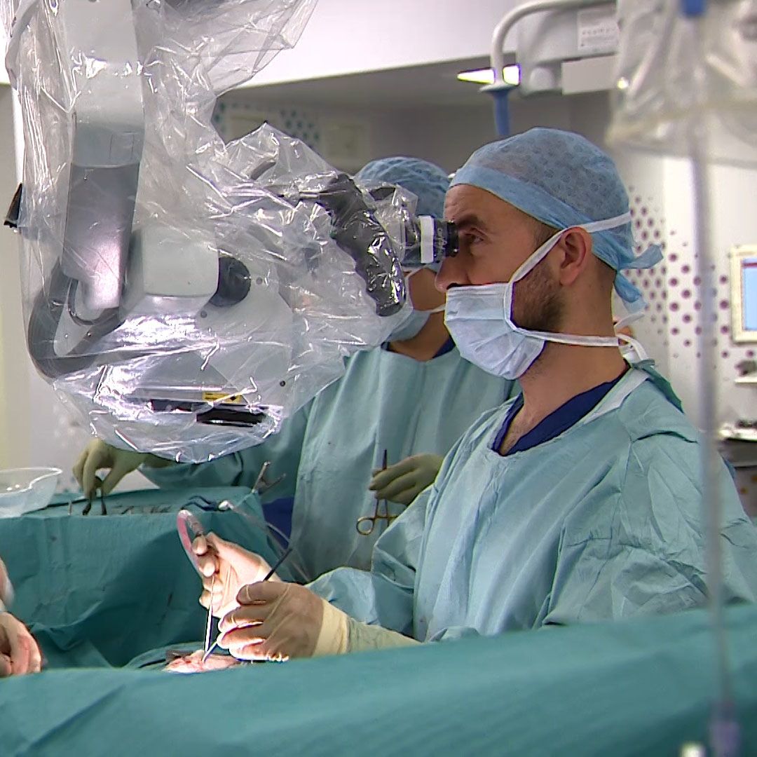 Owase Jeelani looks through the microscope