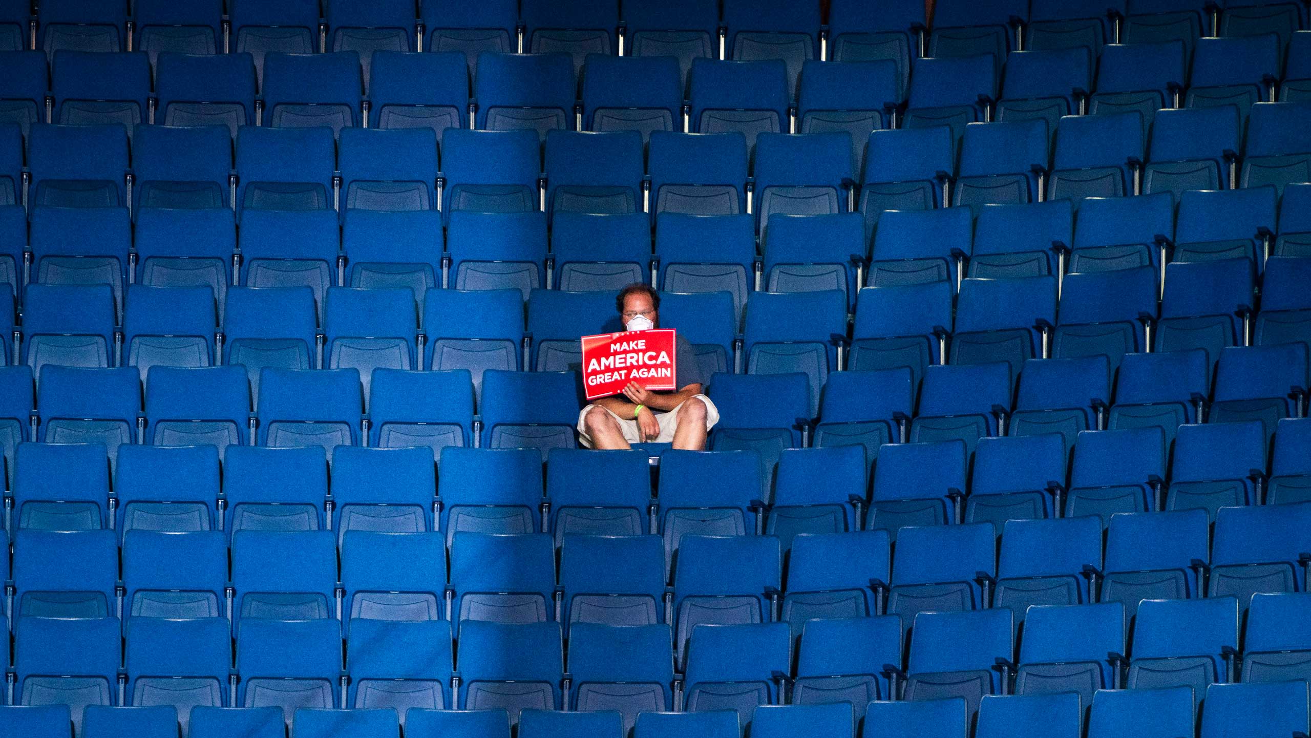 Trump supporter surrounded by empty seats in the Bok Center