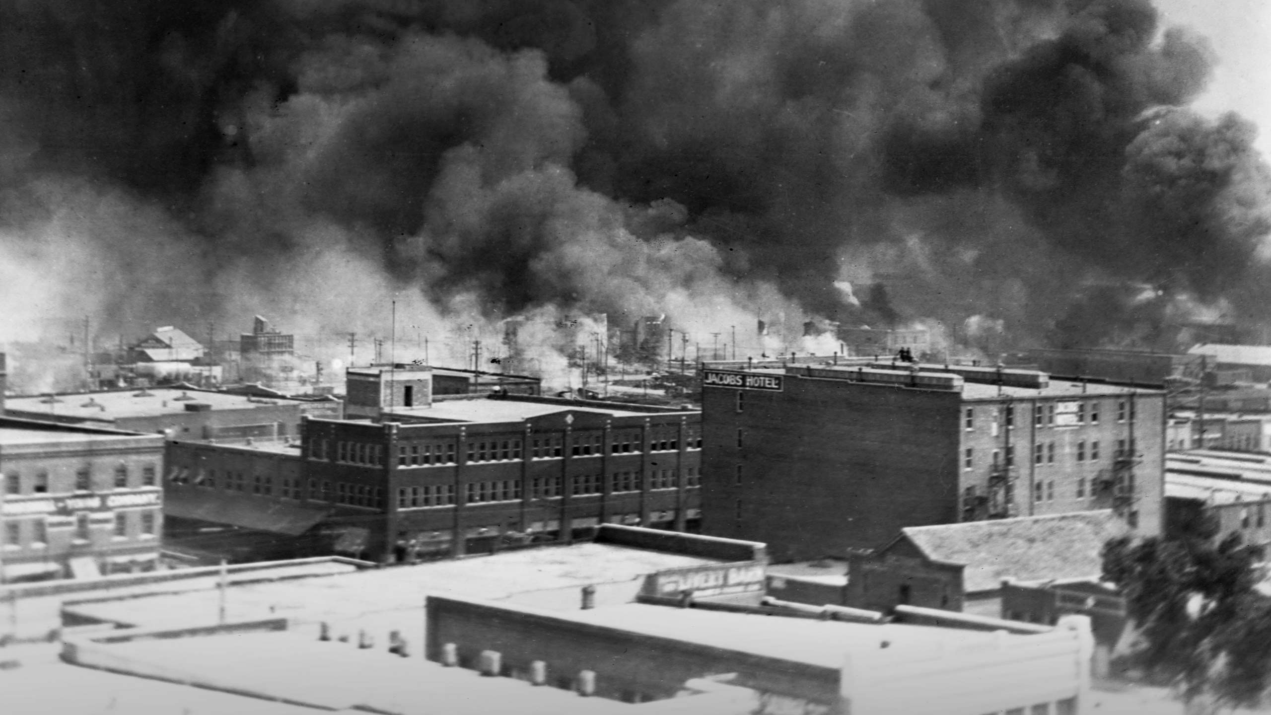 Smoke billows from fires during the Tulsa race massacre of June 1921