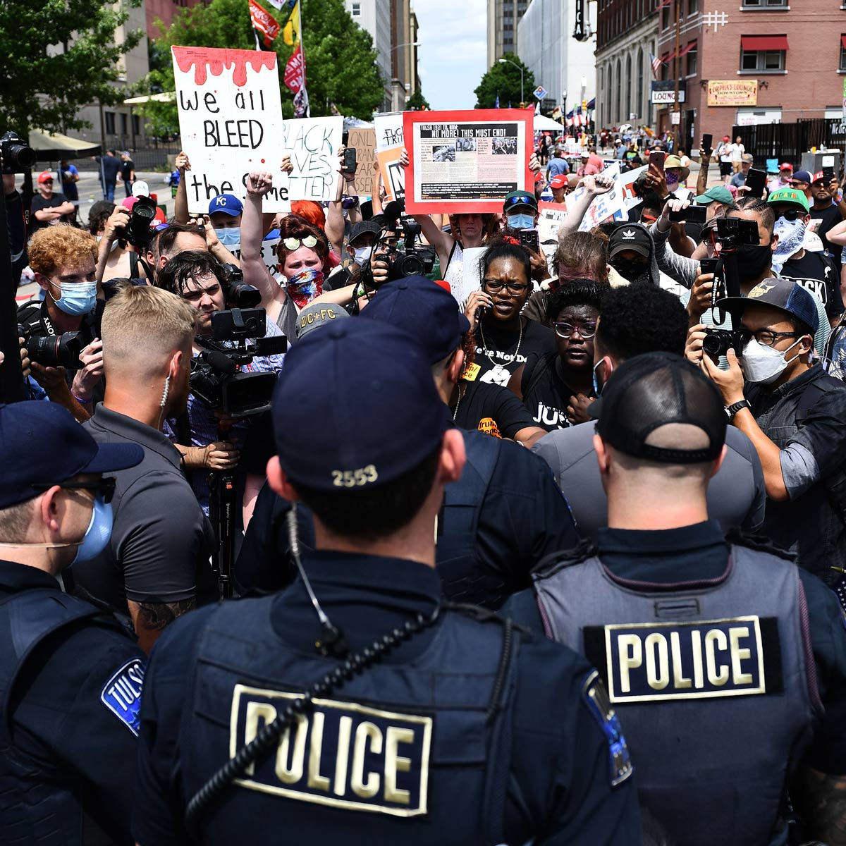Black Lives Matter protesters are stopped by police at the entrance to the Trump rally 